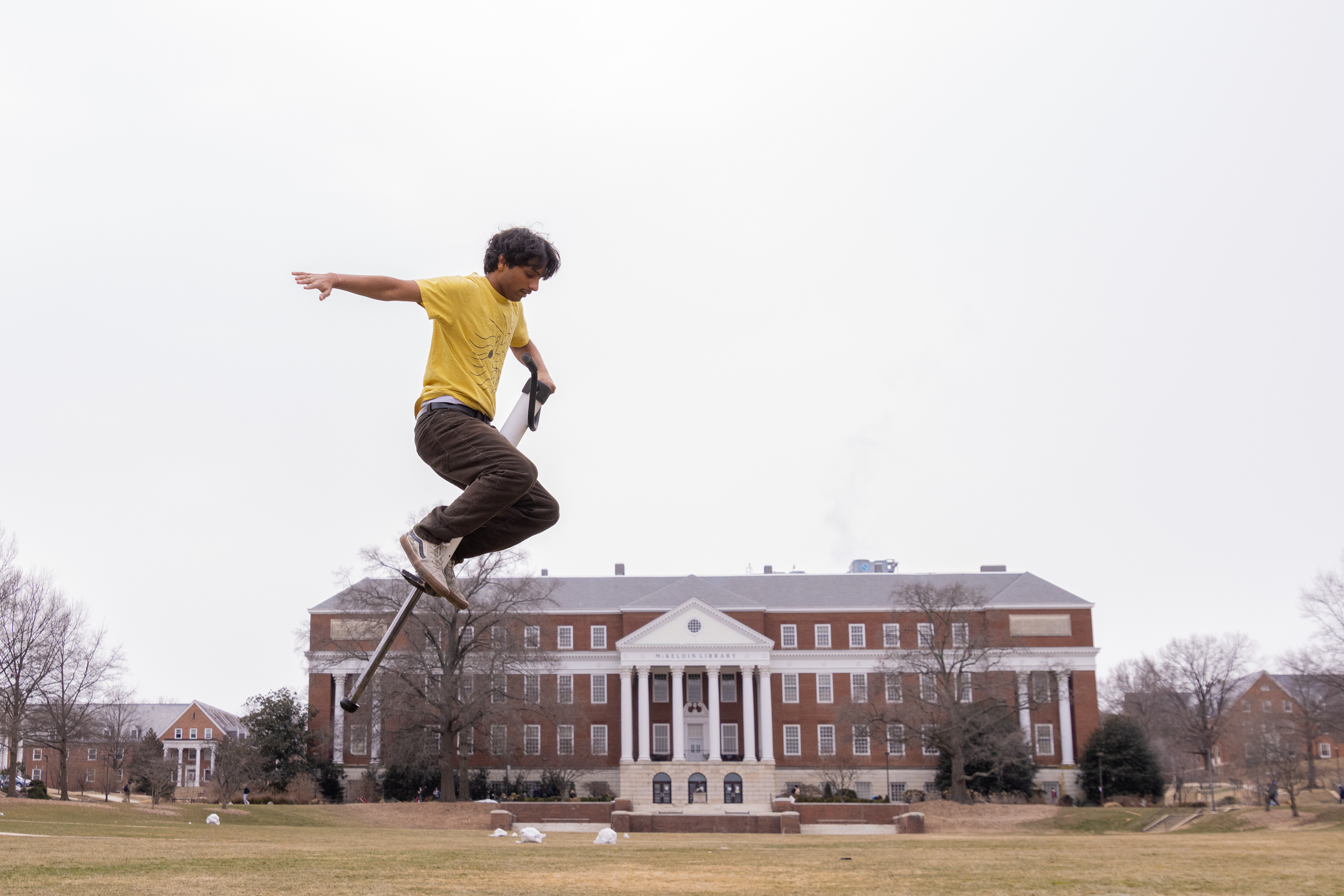 “Pogo stick guy” Ajitesh Kaladi, a senior immersive media design major, jumps with his pogo stick on McKeldin Mall on Feb. 19, 2025. Kaladi spent many of his four years at this university practicing for endurance-based pogo competitions by bouncing around campus, thus earning his nickname.