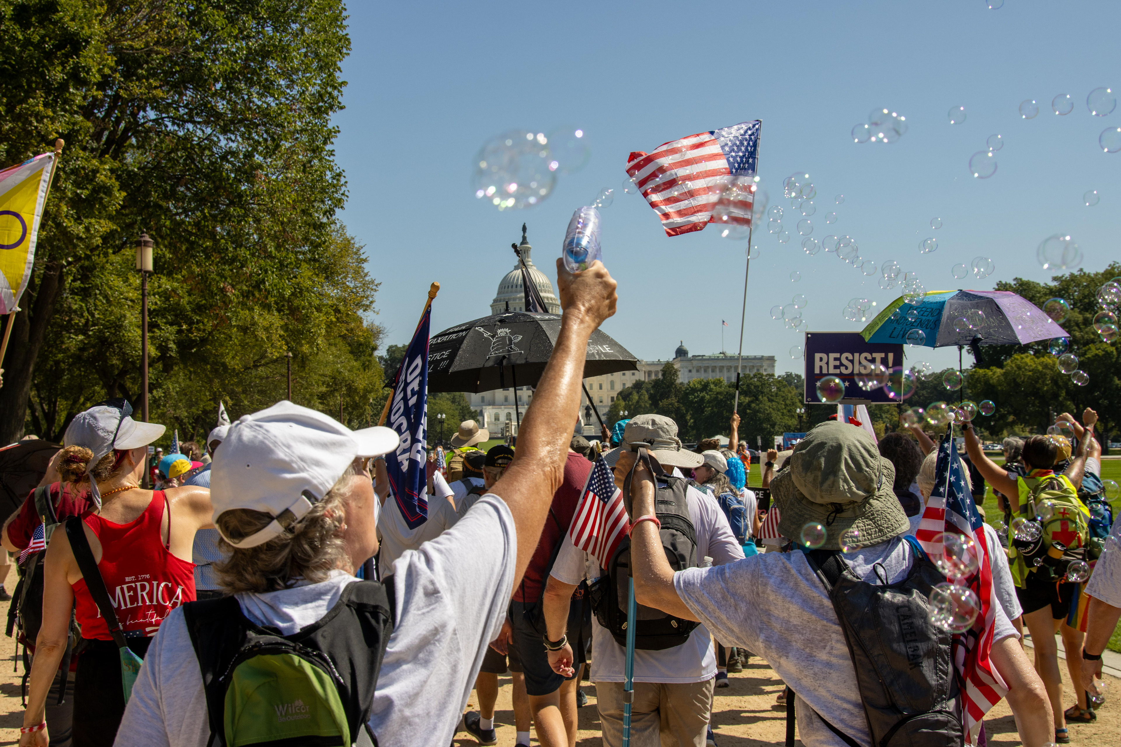 WASHINGTON - A demonstrator uses a bubble gun while walking along the National Mall on Sept. 19, 2025. Participants in the We Are America march walked from Independence Hall in Philadelphia, Pennsylvania to Washington, D.C. between Sept. 6 and Sept. 19 to "hold America accountable" and defend the U.S. Constitution.