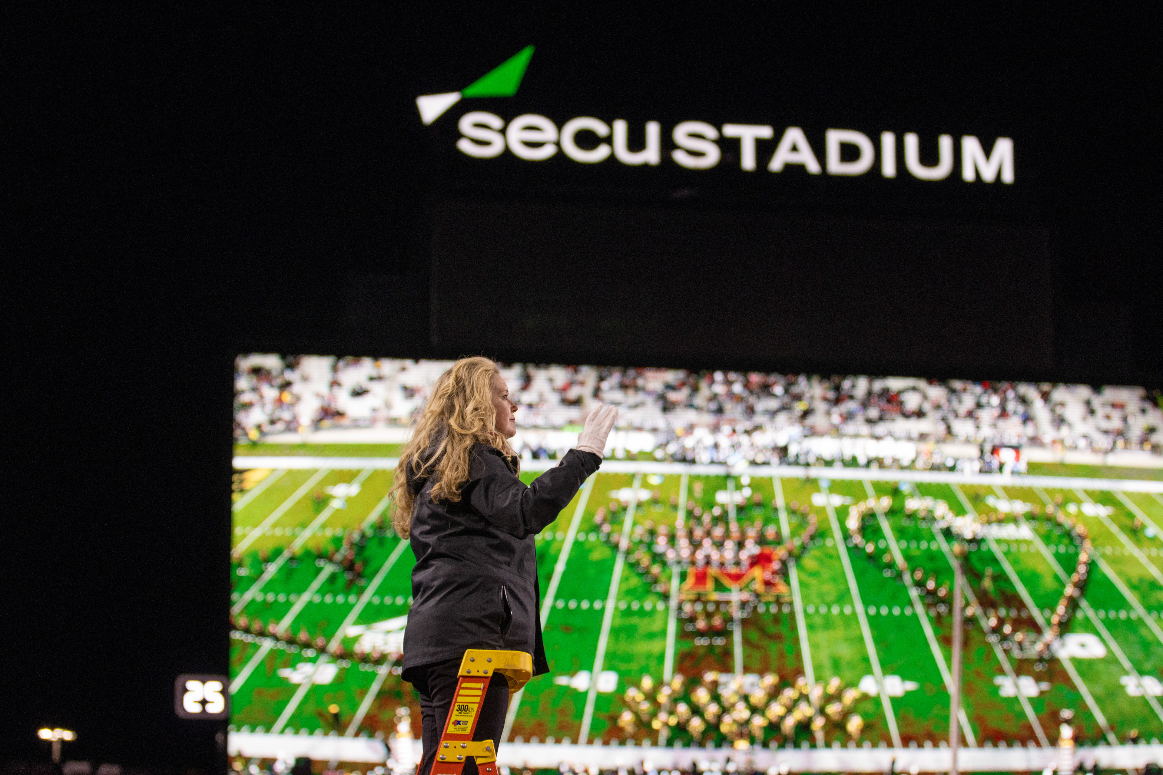 Dr. Andrea Brown, Director of the Mighty Sound of Maryland, conducts the band in their halftime performance of "What is Love" by Haddaway on Nov. 16, 2024. 
