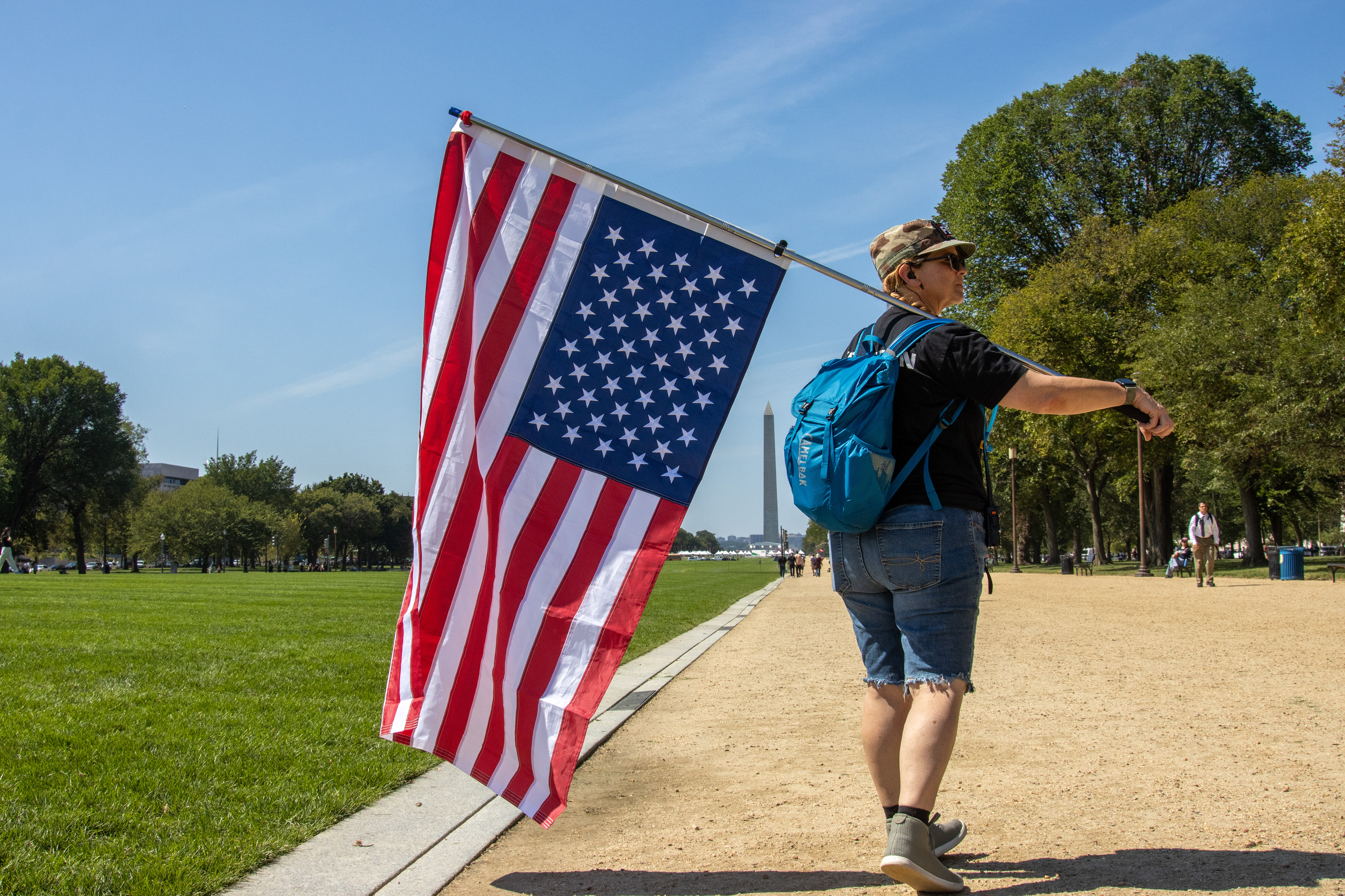 WASHINGTON - A demonstrator carries an upside-down United States flag on the National Mall on Sept. 19, 2025. Participants in the We Are America march walked from Independence Hall in Philadelphia, Pennsylvania to Washington, D.C. between Sept. 6 and Sept. 19 to "hold America accountable" and defend the U.S. Constitution.  (Sam Cohen/Capital News Service)