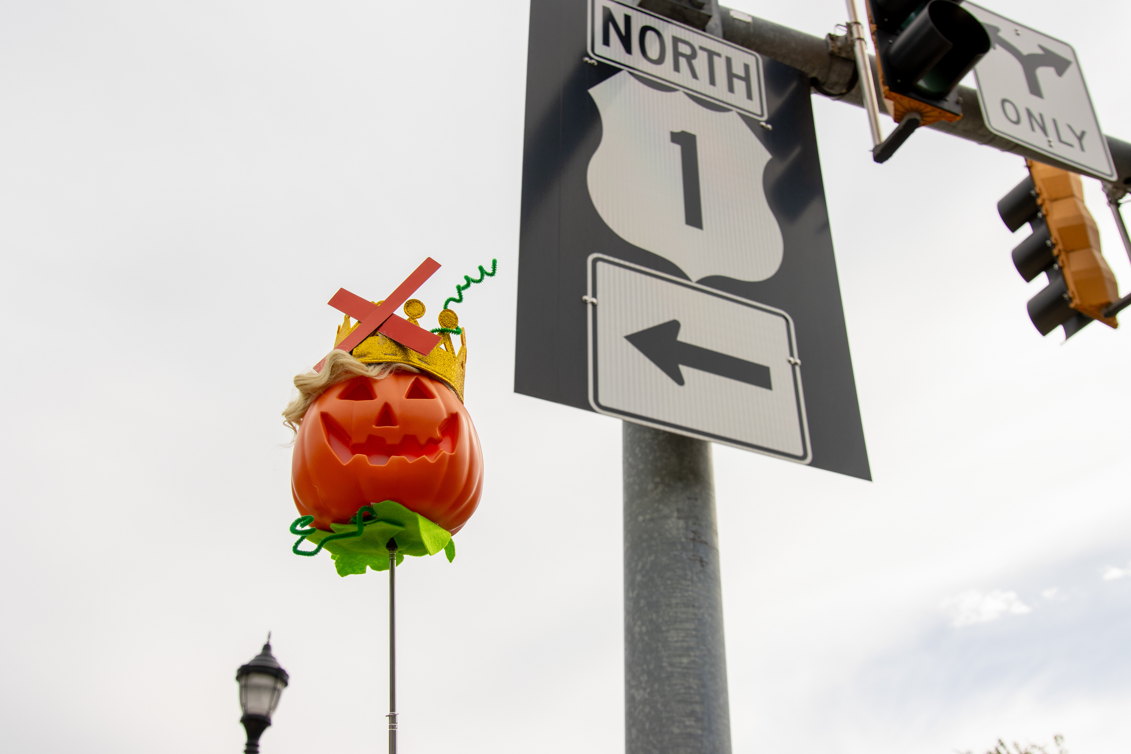 A person holds a “Trumpkin,” a pumpkin styled as U.S. President Donald Trump, near Route 1 on Oct. 18, 2025. 