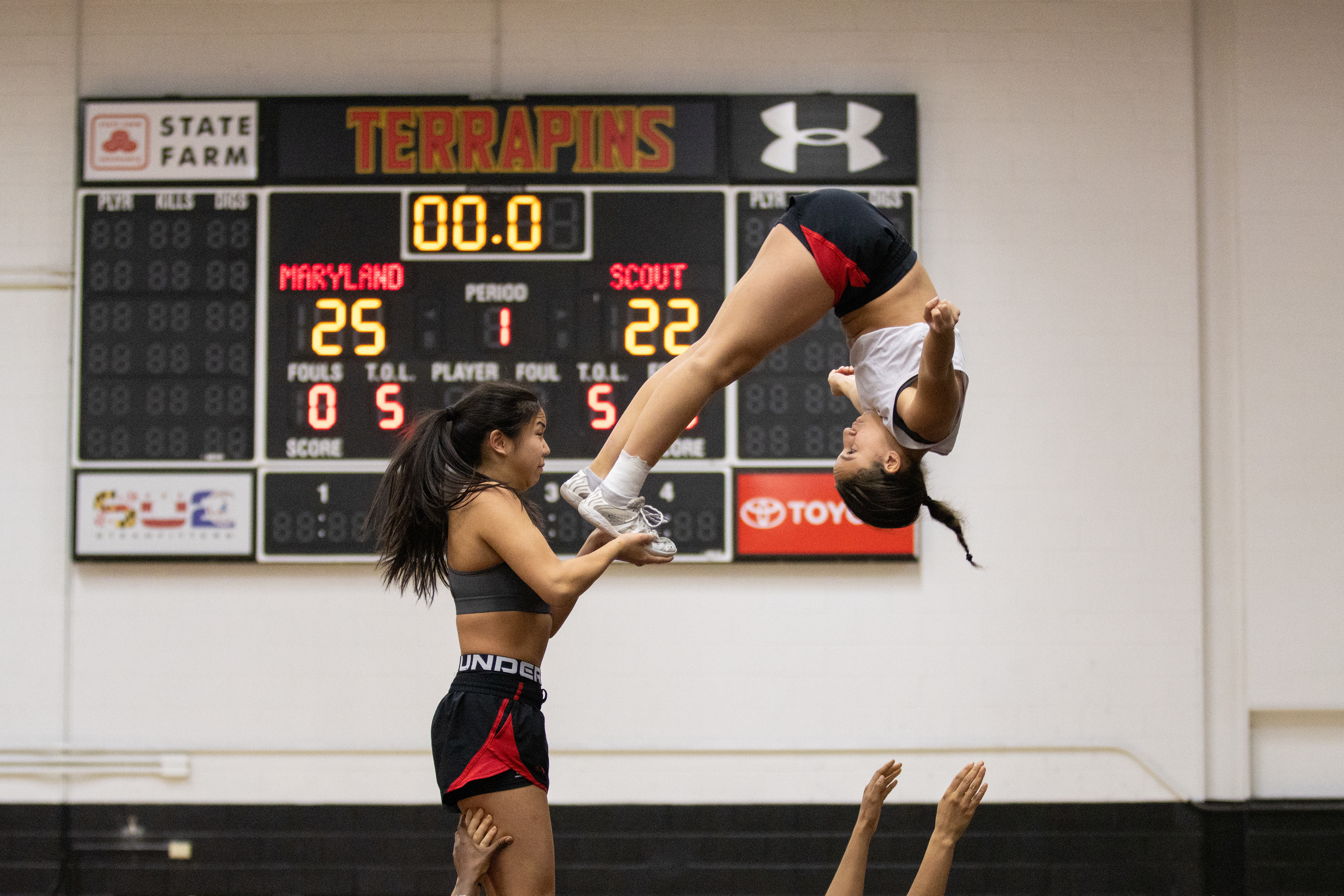 Flyers Morgan Kim and Addison Reed practice part of the pyramid during practice on March 4, 2025. Pyramid stunts are a key and complex element of a collegiate cheerleading routine.