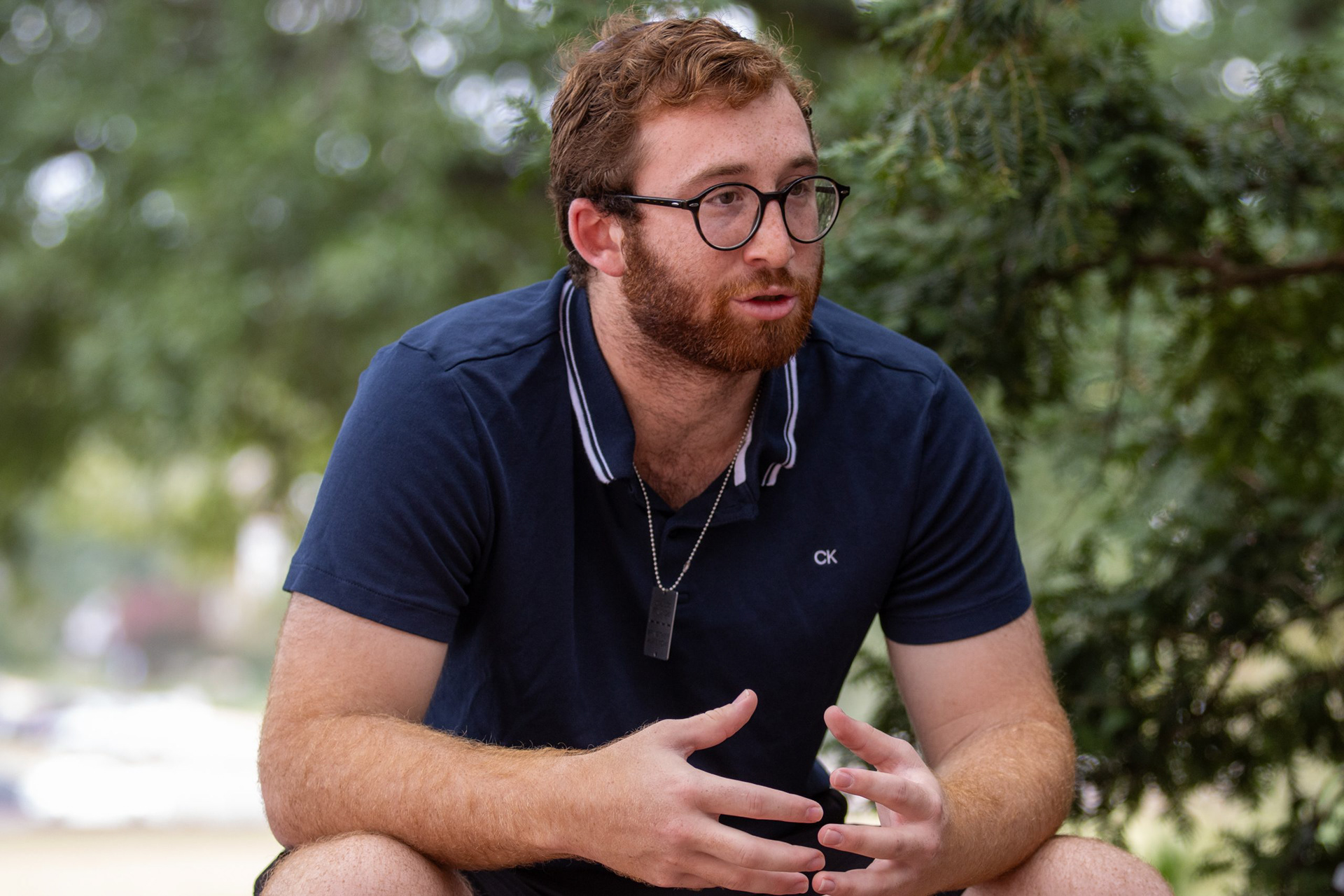Stone Schwartz, a junior mechanical engineering major, reflects upon the recent killing of six hostages in Gaza while sitting in the Chapel’s Garden of Reflection and Remembrance on Sept. 13, 2024.