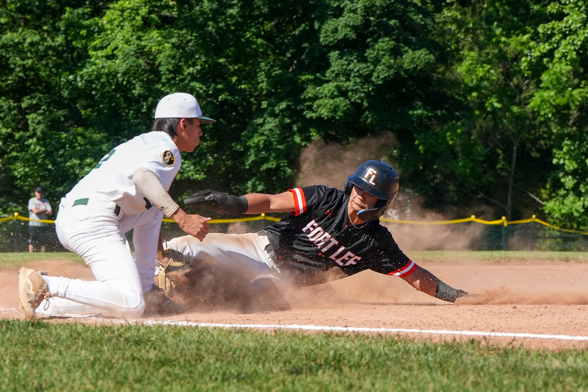 Fort Lee junior Stephan Kim (9) slides into third base while Ramapo senior Brandon Bodart (5) catches the ball during a semifinal game on Jun 3, 2026 at Ramapo High School in Franklin Lakes, New Jersey.