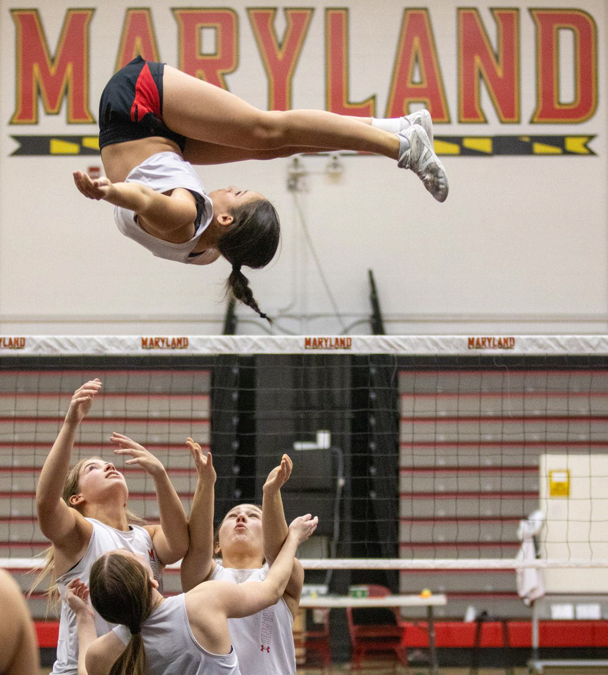 Addison Reed, Brooke Denmark, Rylie Gross and Kerrin Kelsey perform a dismount at a Maryland Cheer team practice inside Xfinity Center Pavilion on March 4, 2025.