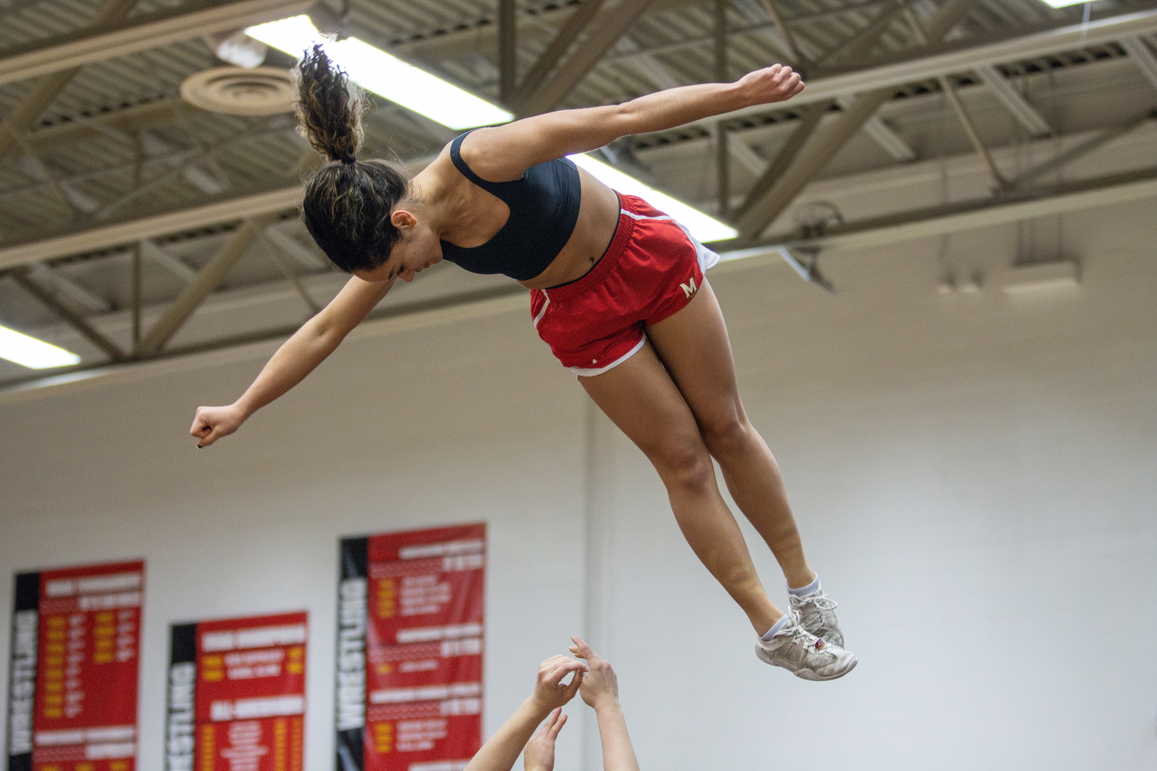 Junior Lilymar Torres Santana completes a full twisting layout during Maryland cheer's practice.