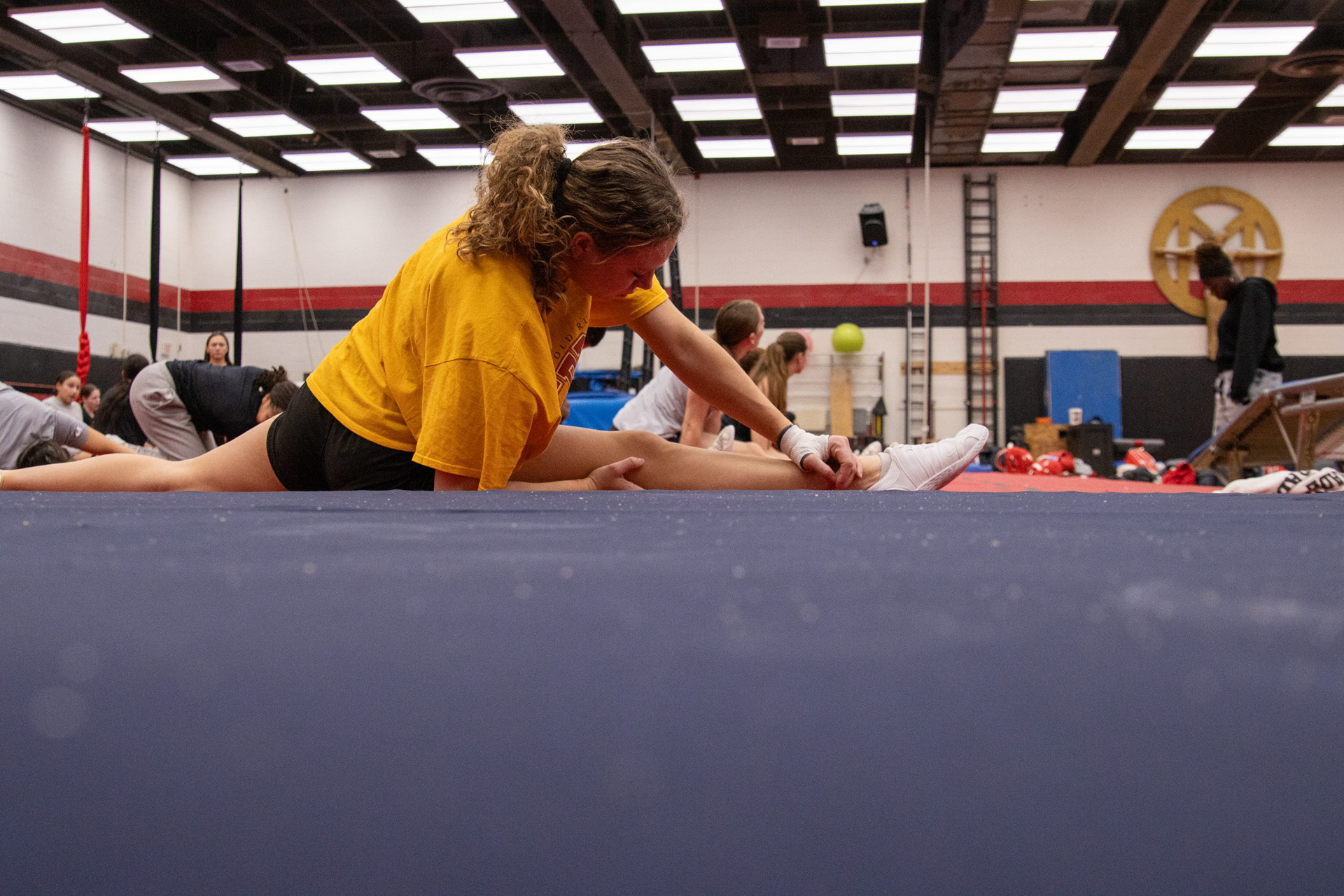 Sophomore Rachael Young stretches during Maryland cheer’s practice in the public health school on March 10, 2025.