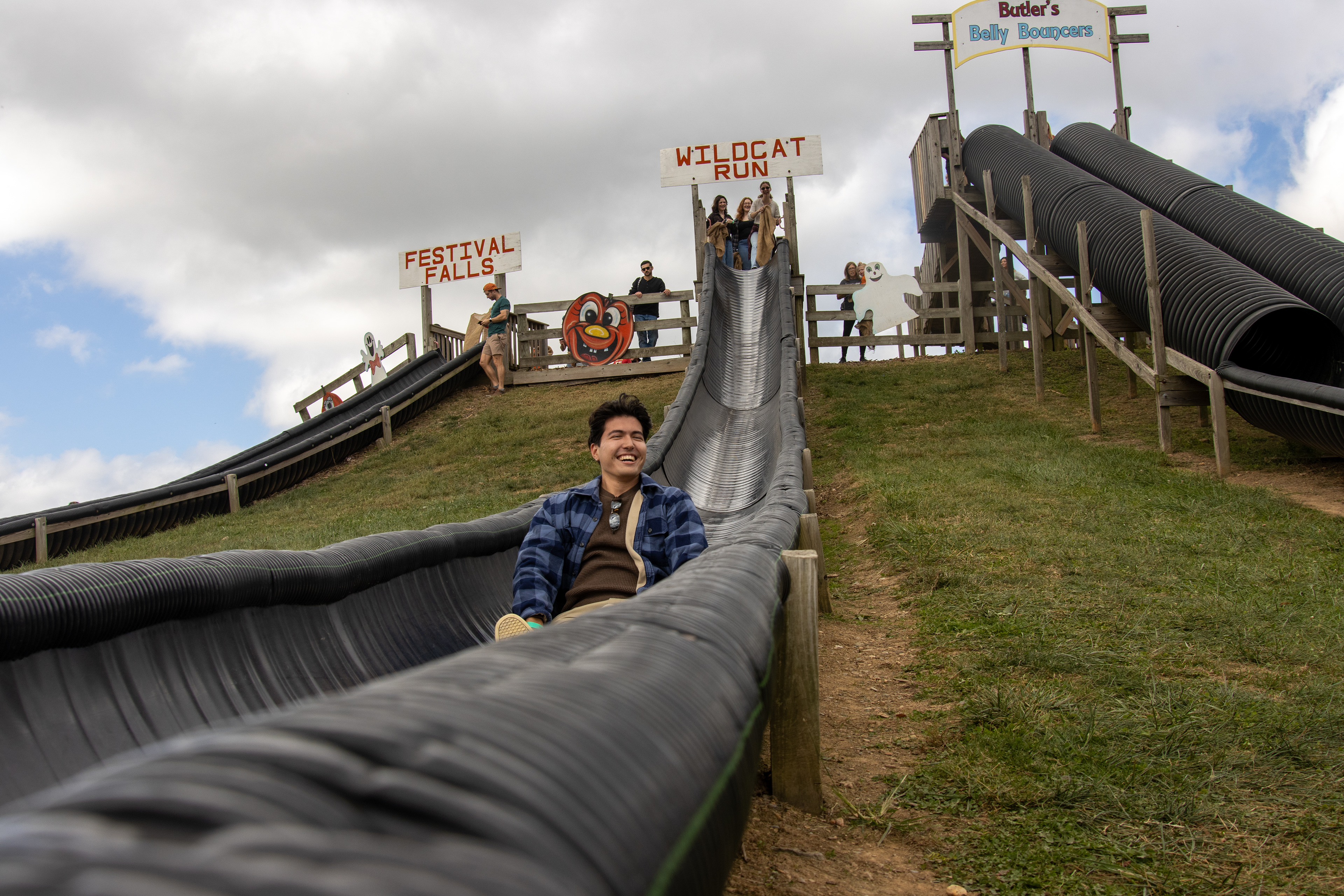 A person slides down the Wildcat Run slide at Butler's Orchard on Oct. 11, 2025.