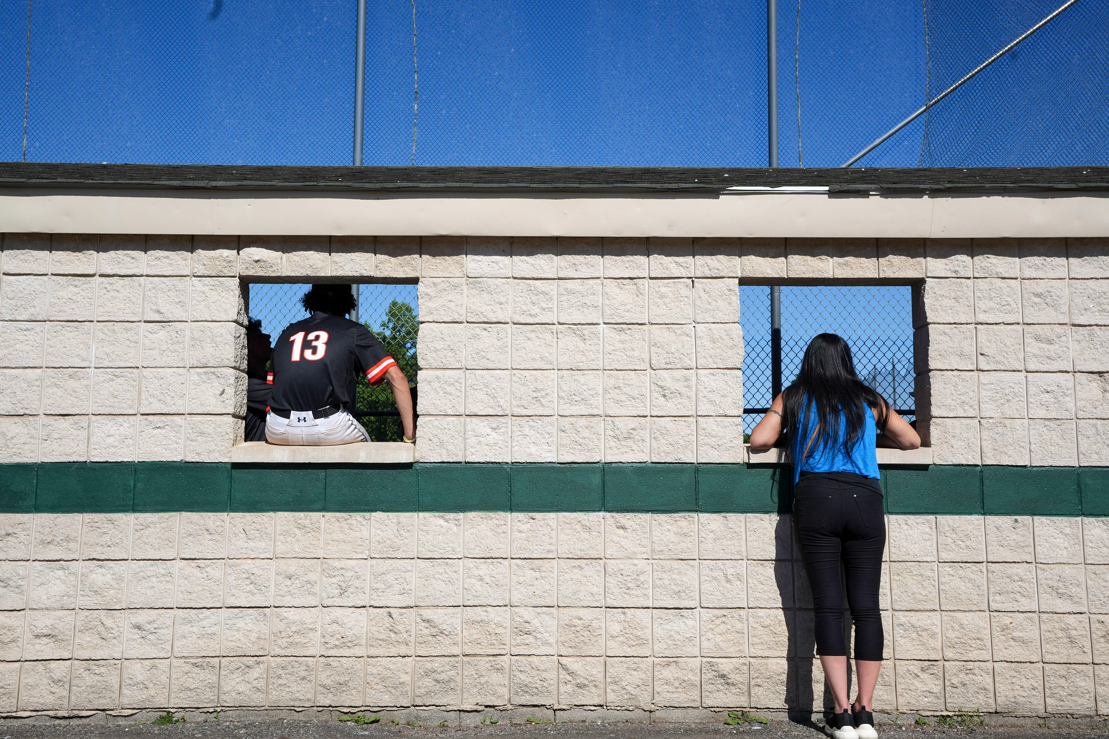 Fort Lee sophomore Dylan Toribio (13) and a spectator watch the semifinal game against Ramapo on Jun 3, 2026 at Ramapo High School in Franklin Lakes, NJ.