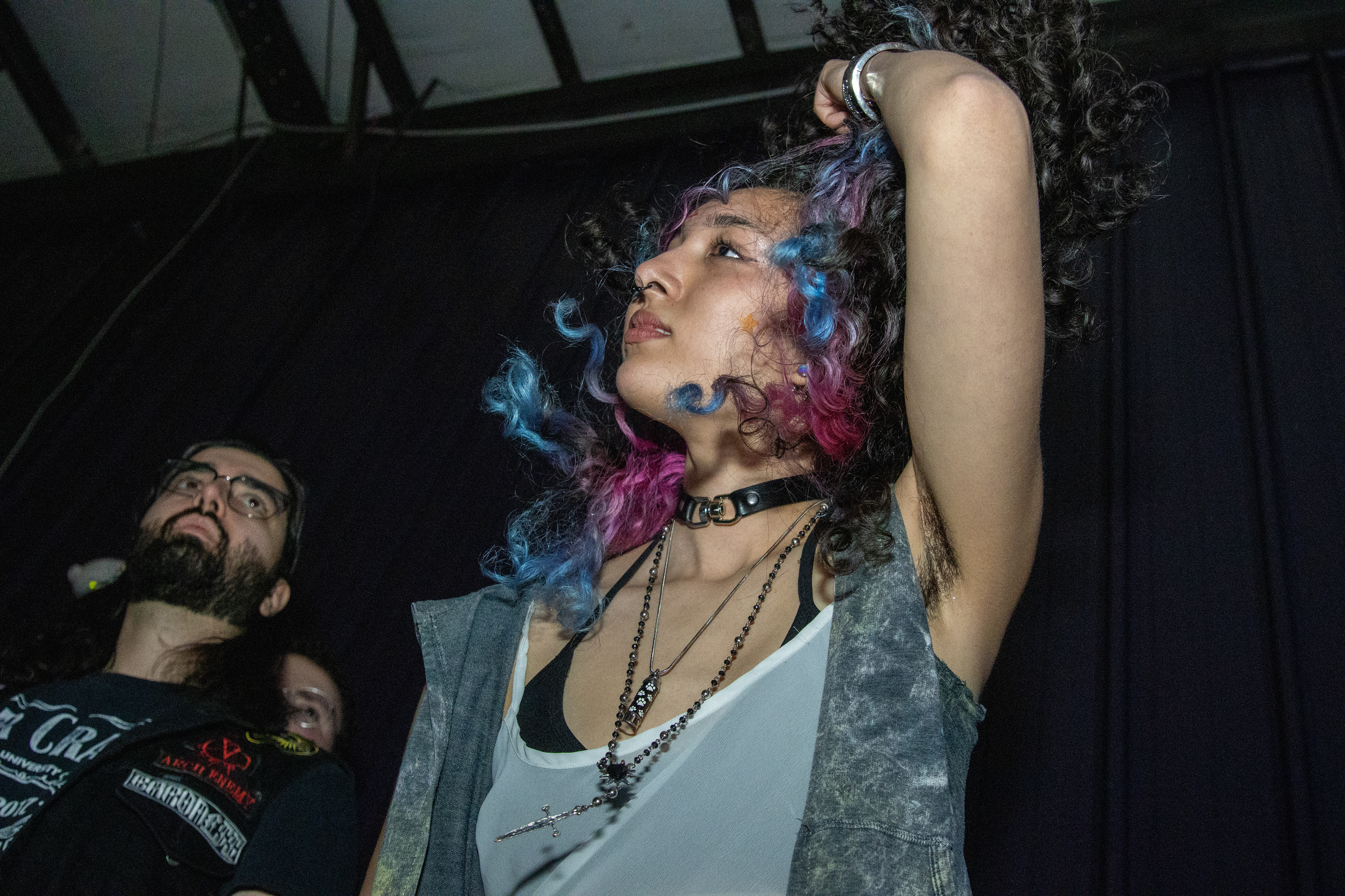 A Shellfest II attendee pushes their hair back on Dec. 7, 2025.
