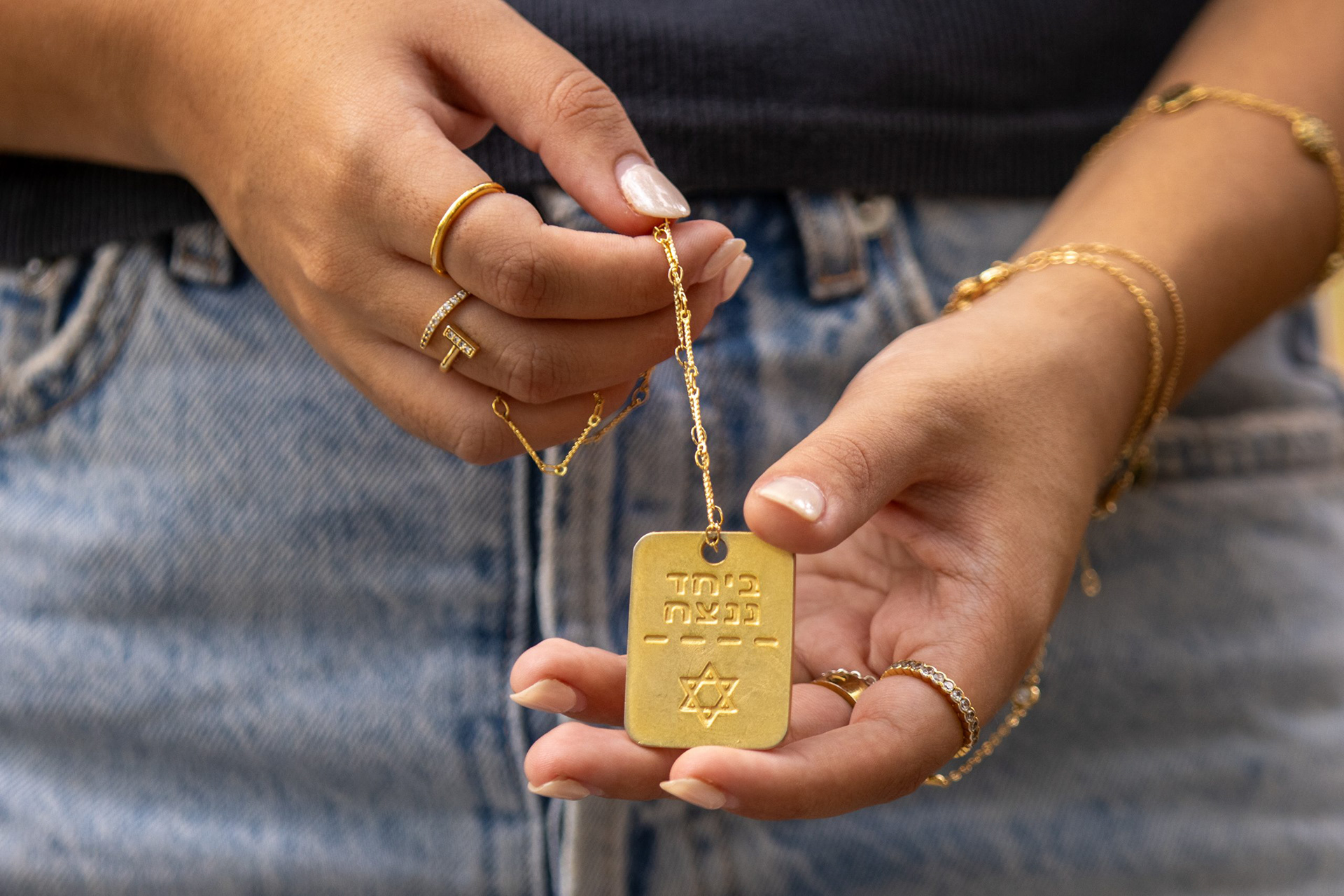 Ella Elimelech displays a necklace which reads “beyachad nenatzeach,” translated from Hebrew as “together we will win.”