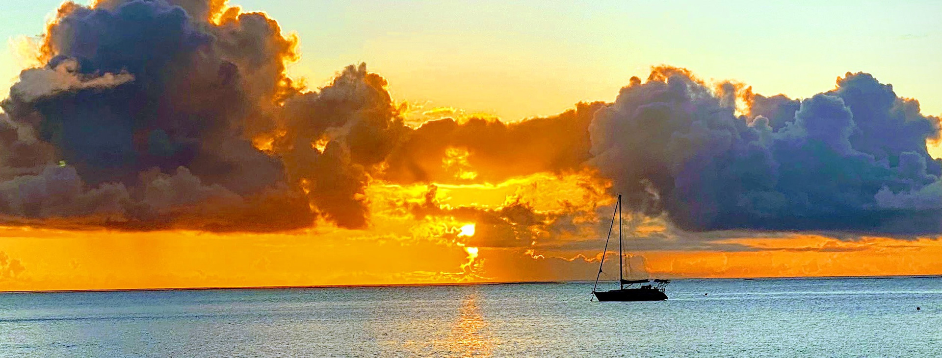 Sailboat against a sunset. Links to the course Sailboat 101