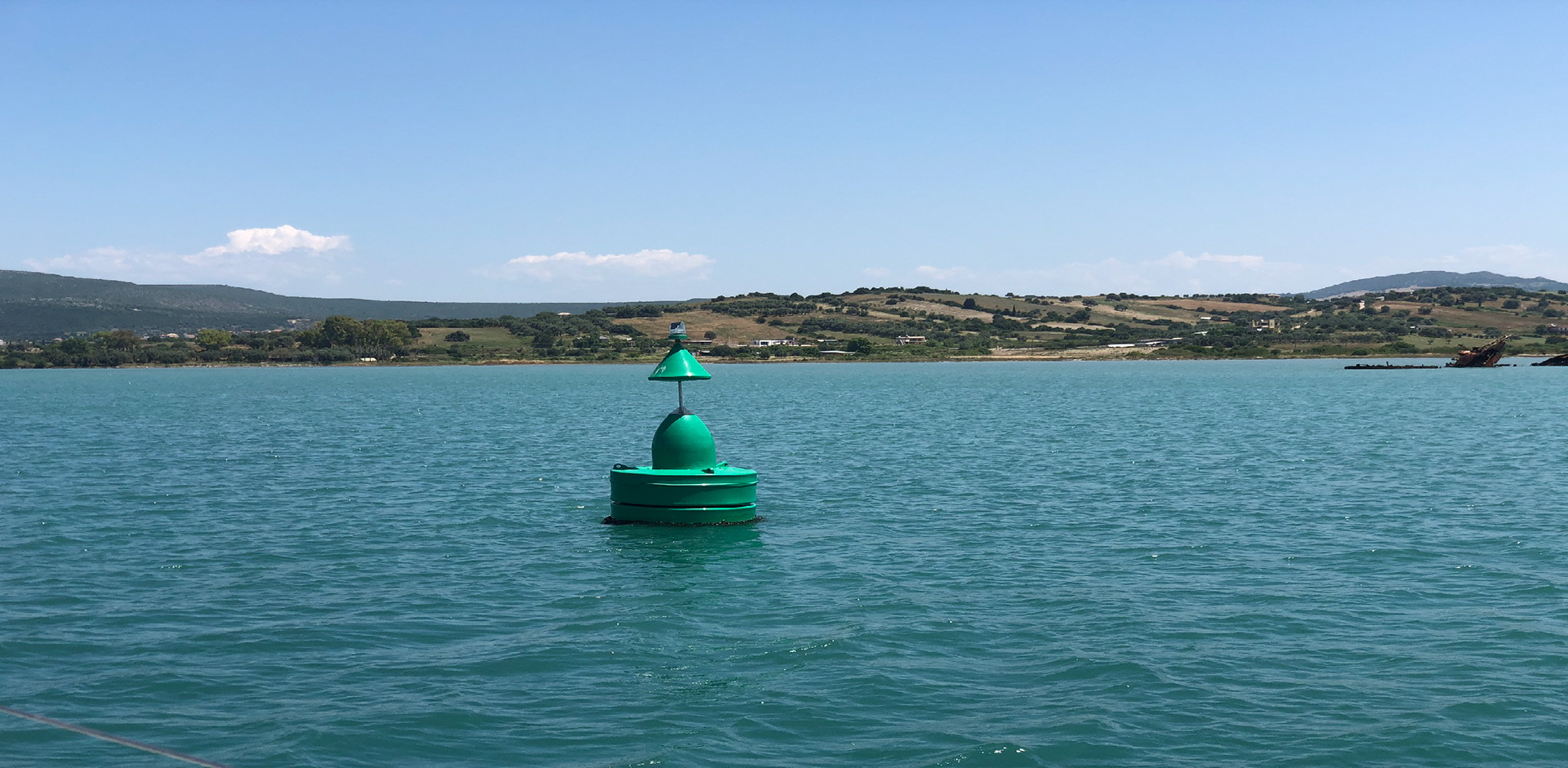 Green channel marker with the Grecian landscape in the background