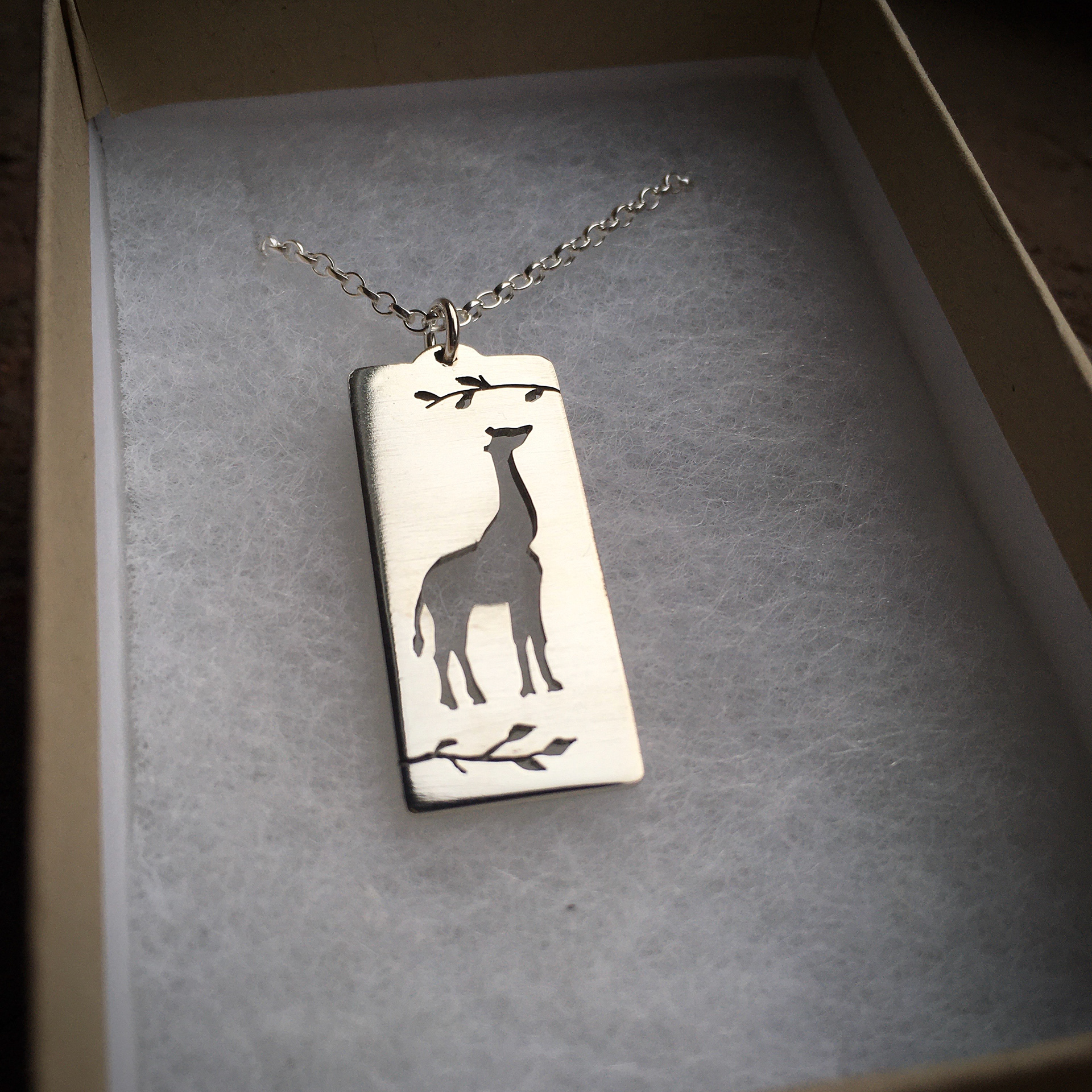 Custom giraffe with initial on reverse.