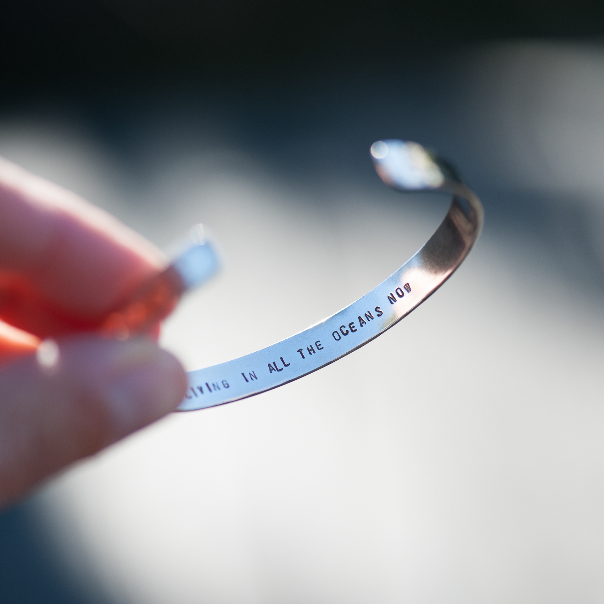 Hammered bangle with custom words inside.