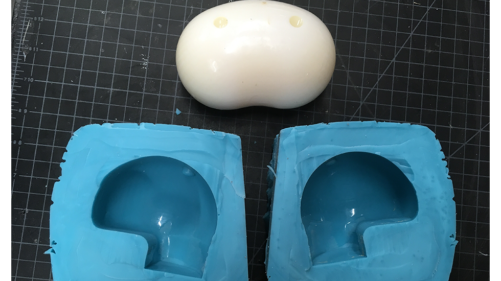 The 3D printed jelly bean and mold used to cast the final holds