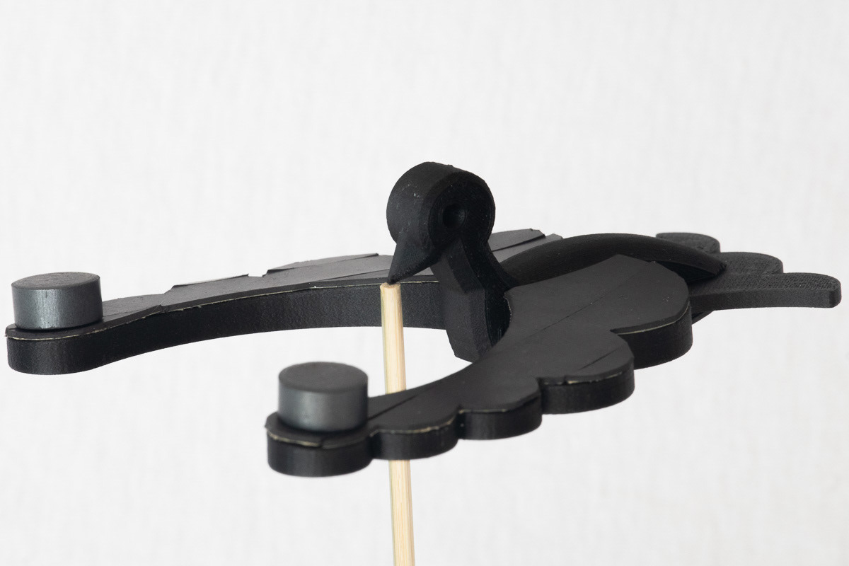 Center of Mass and Symmetry: Balancing bird