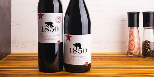 Two bottles of wine on counter top