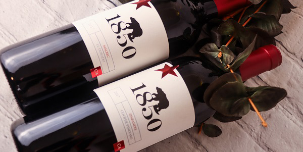 Two bottles of wine laying down