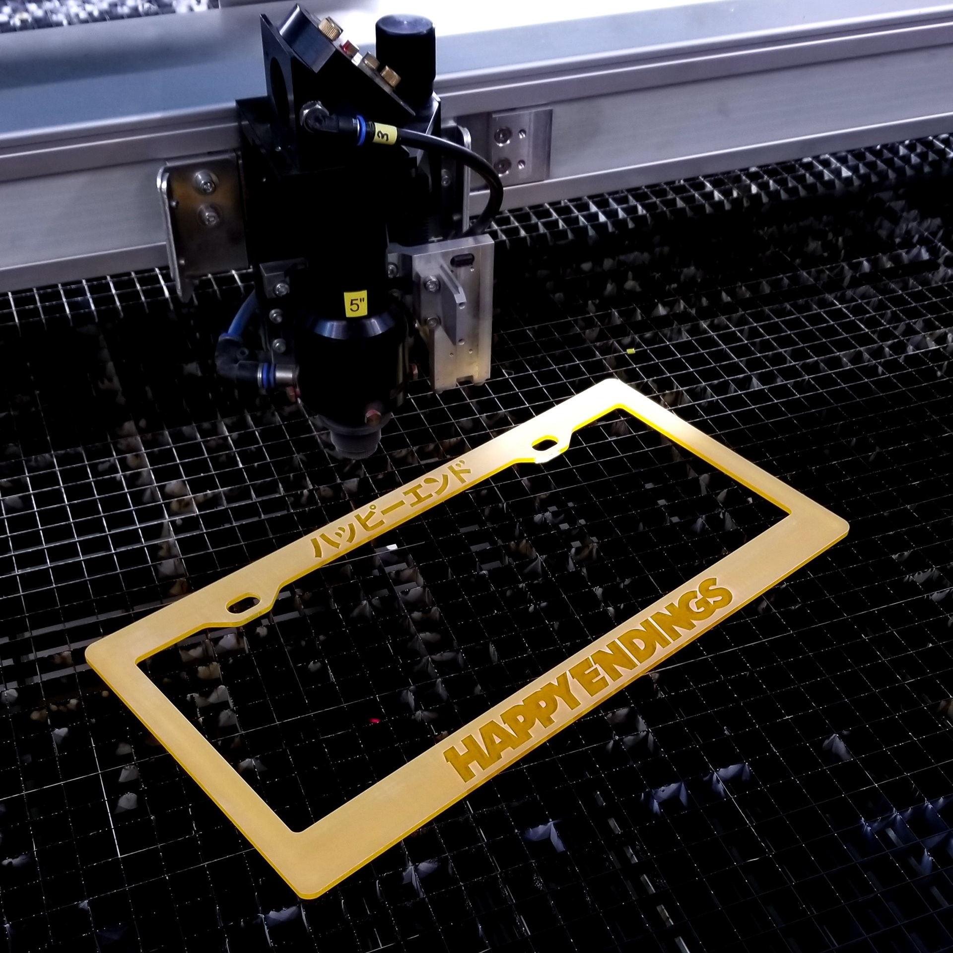 CNC laser engraved and cut Happy Endings license plate frame.