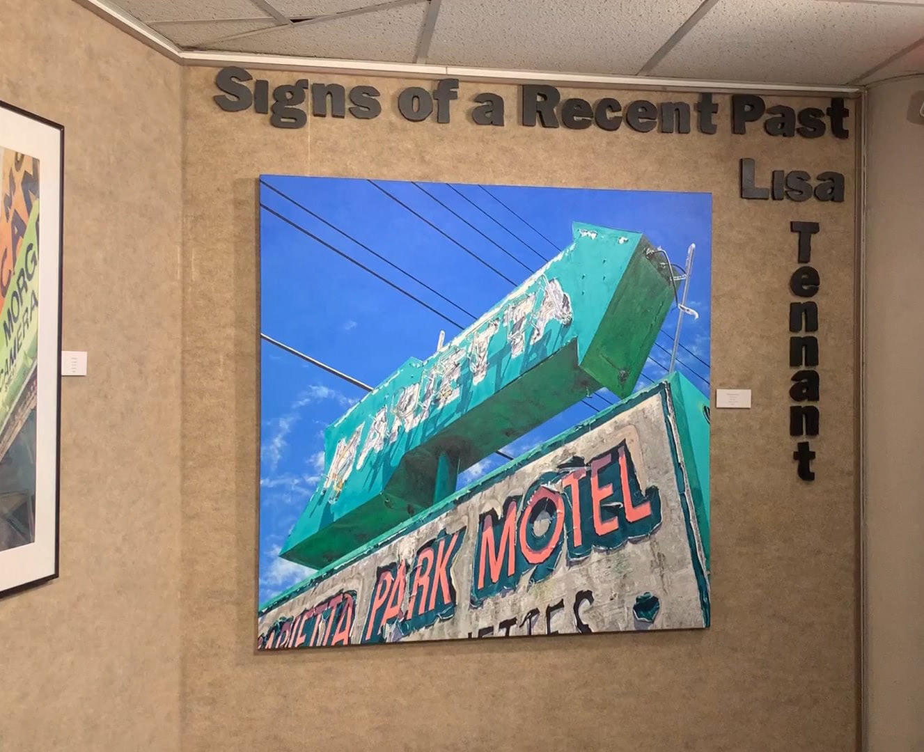 the painting is shown hanging on a wall of the gallery