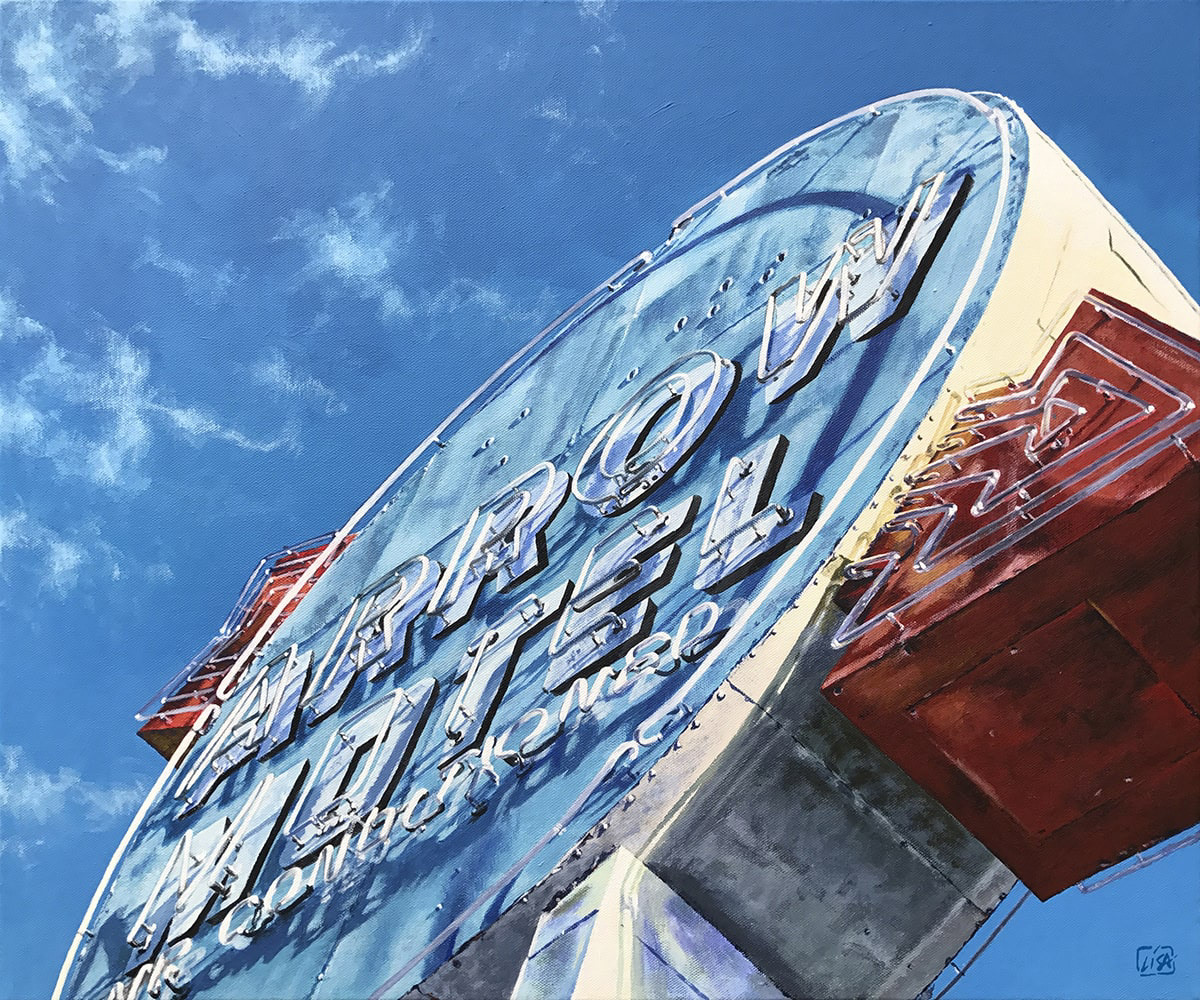 image of the Arrow Motel neon signage with clouds overhead
