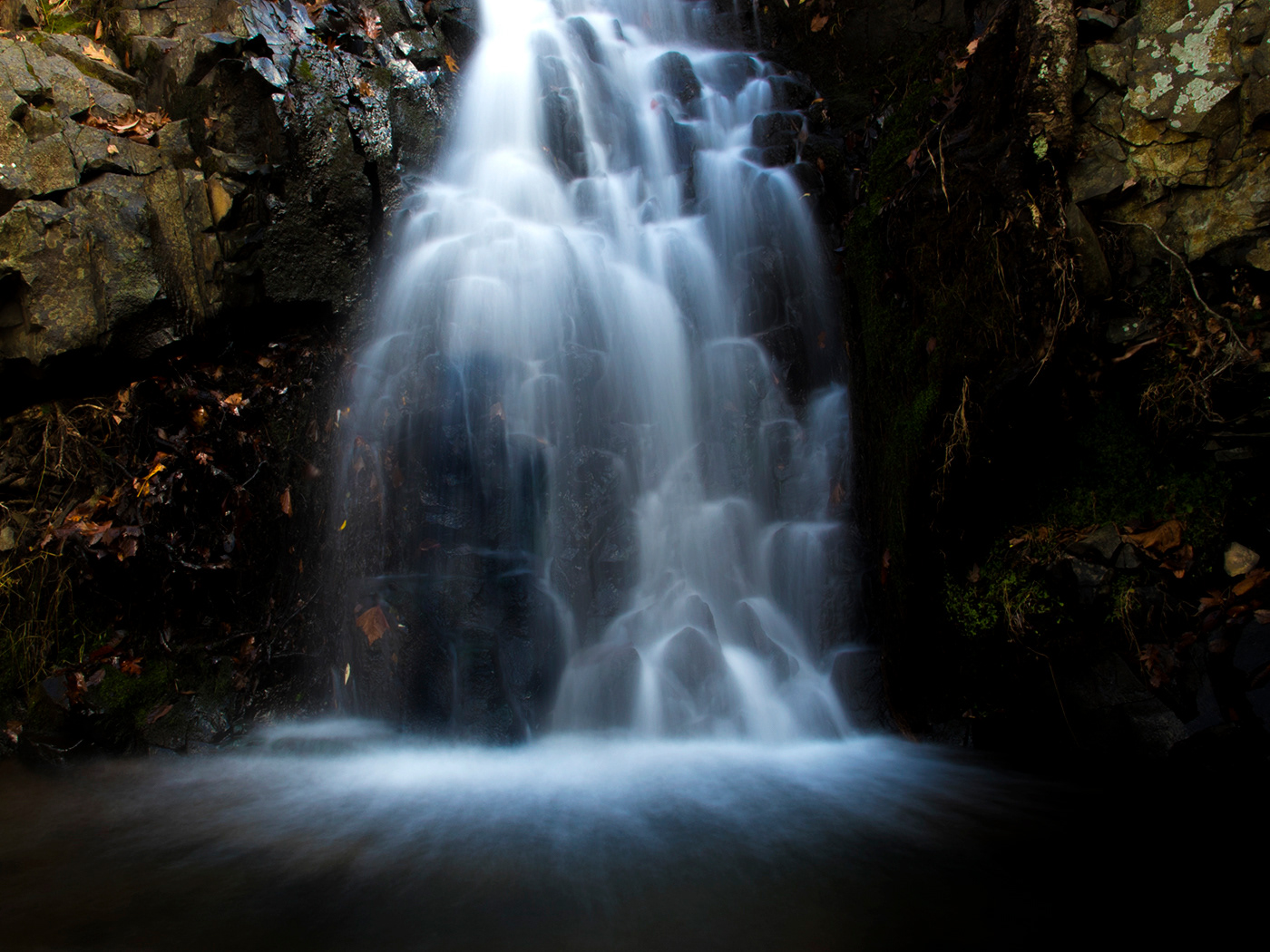 Man sitting under falls