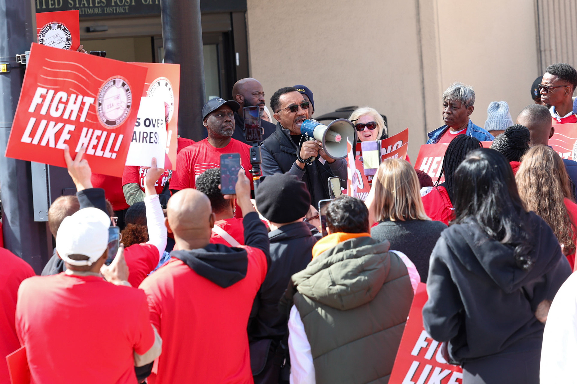 March 23, 2025, United States Postal Service, Baltimore, Maryland, USA. Hundreds of postal workers and union members rallied in front of the post office in protest of DOGE cuts and the Trump administration's interest in privatizating of the United States Postal Service. Photo Credit: Robyn Stevens Brody/Sipa USA.