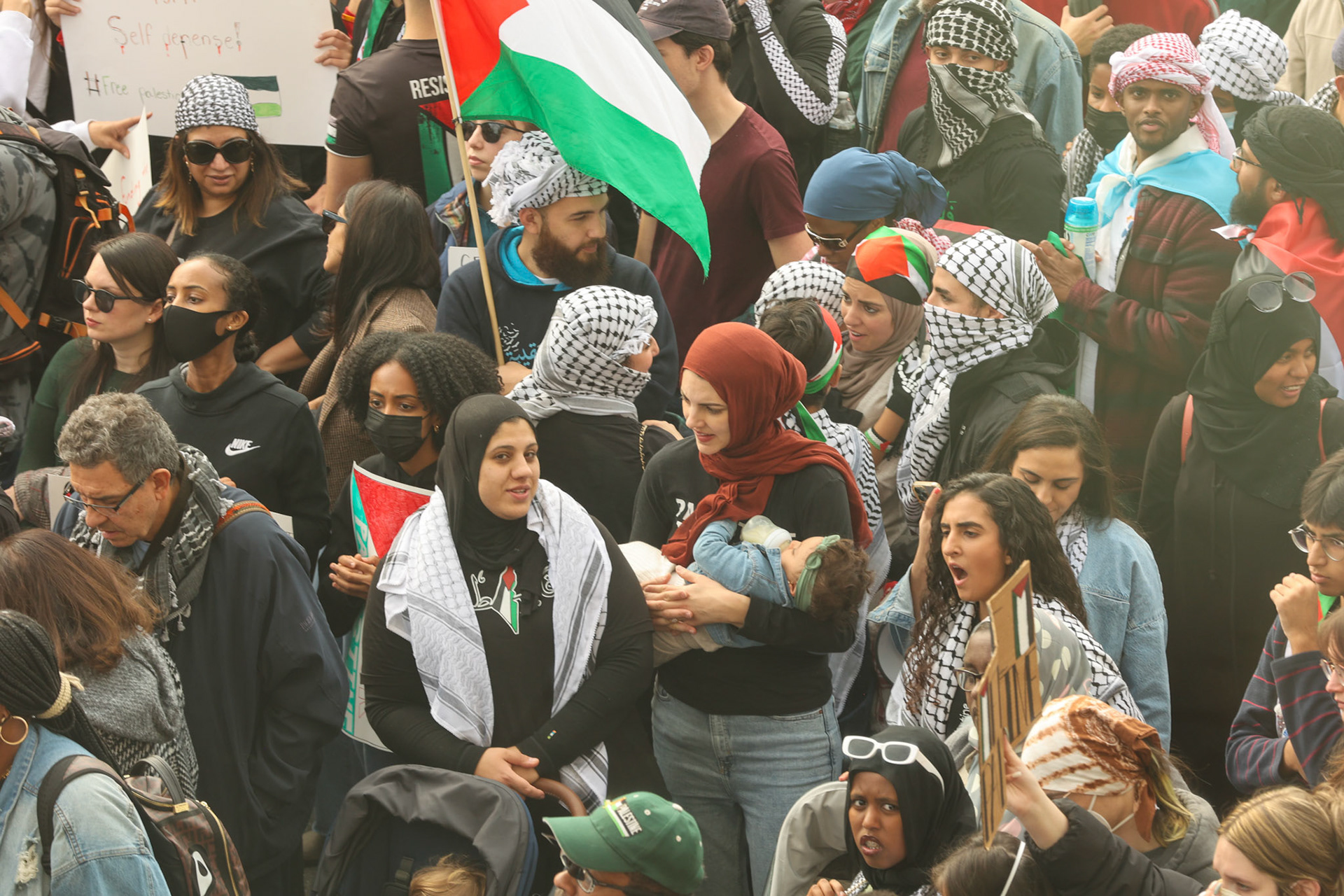 November 4, 2023 - A mother holds her baby in during the Pro Palestine Rally in DC..