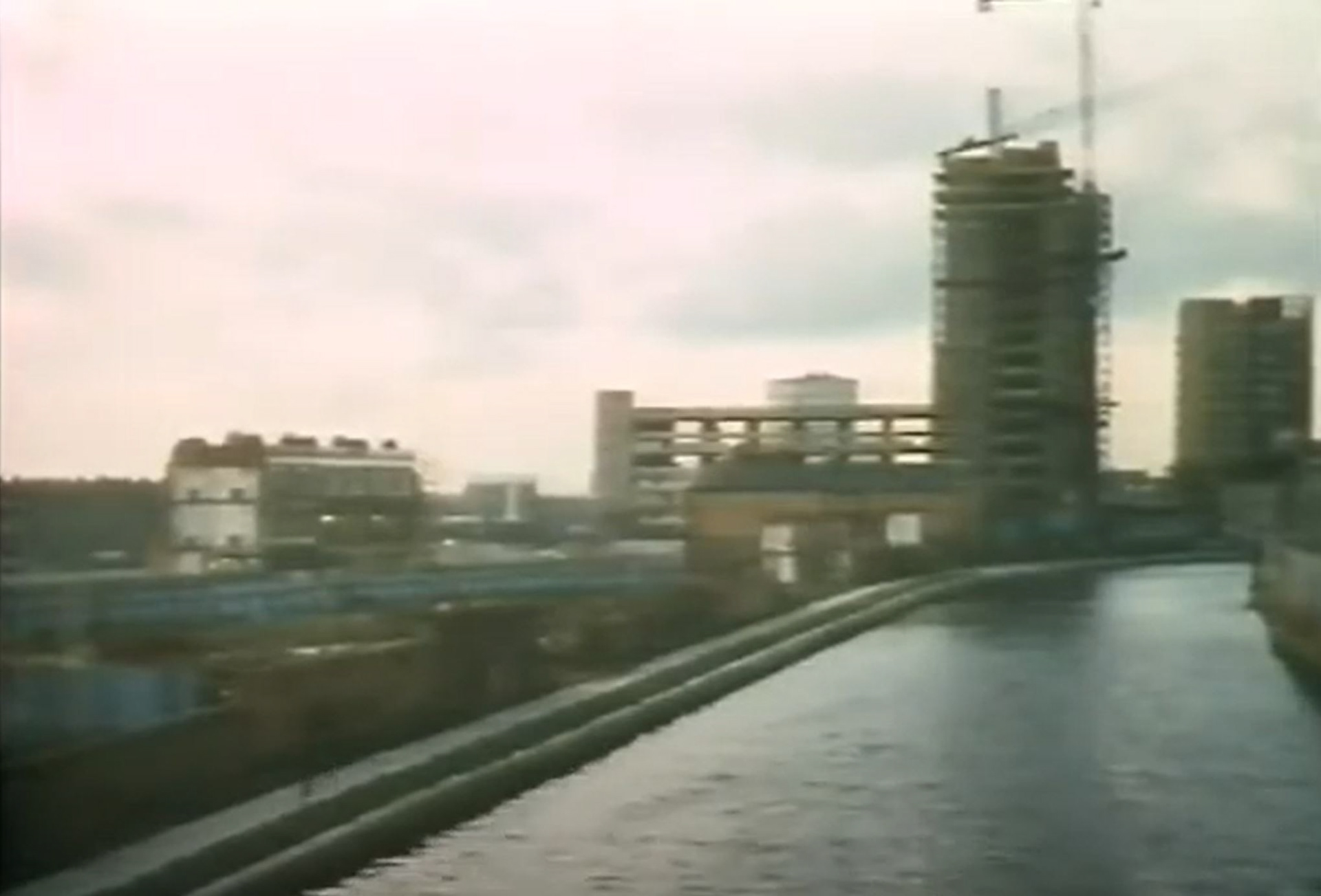 Scene from Freelance - Ian McShane running down the canal. Trellick Tower under construction in the background