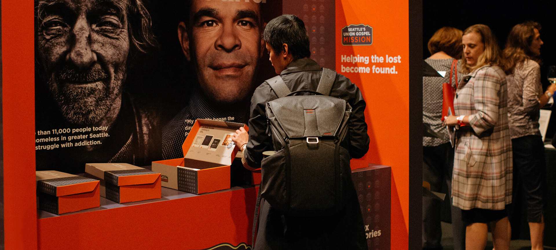 A patron at the 2019 Catalyst Gala engages with one of the interactive kiosk on view.