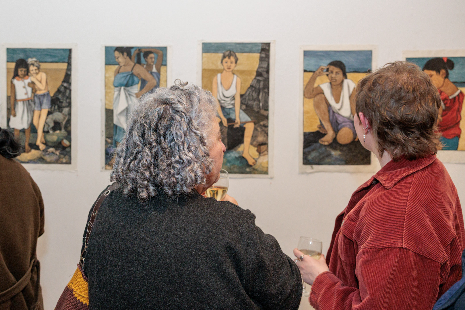 Attendees examine the art at Dame Robyn White's opening