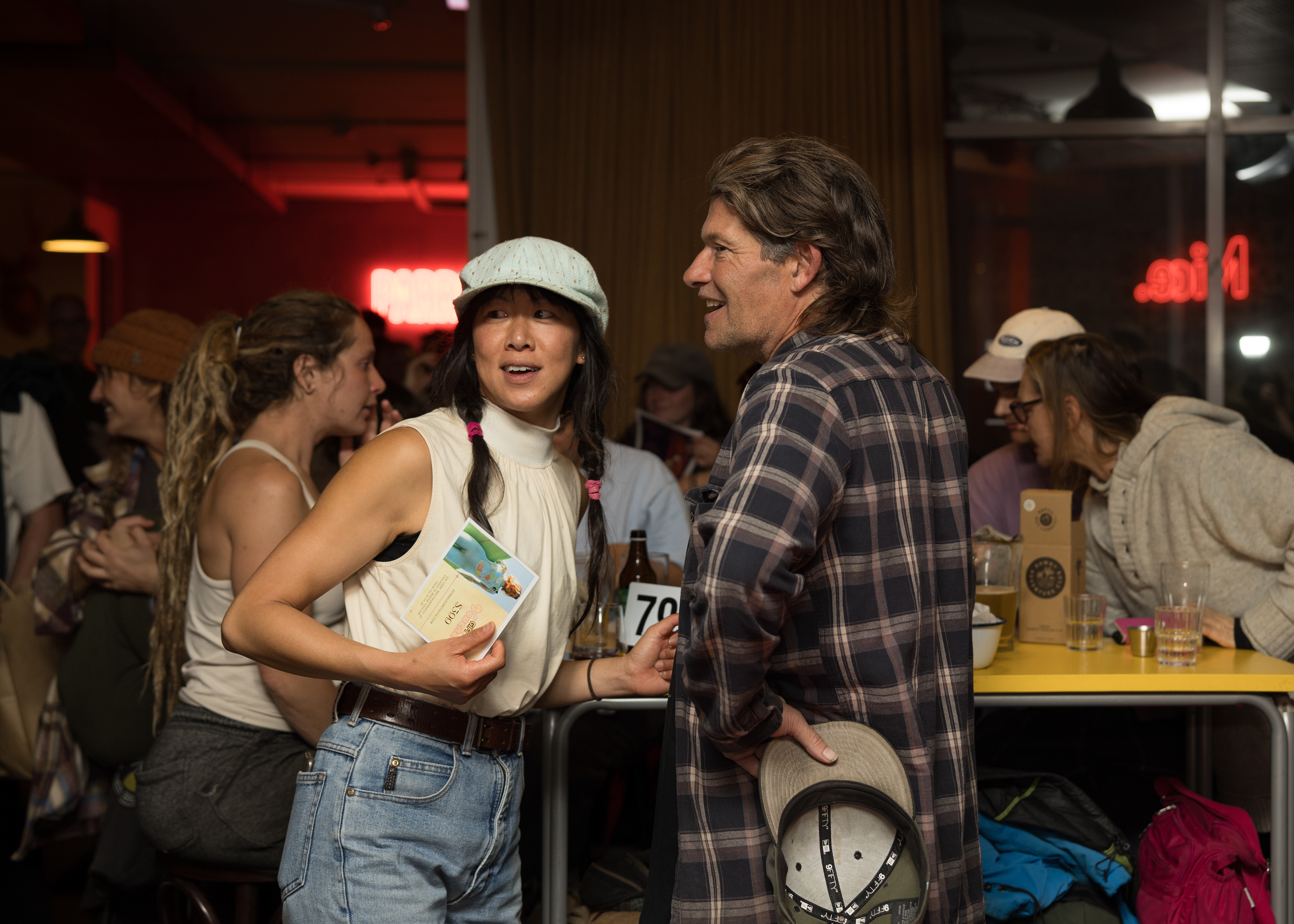 Surfer and performer Nikita 雅涵 Tu-Bryant, chats with a friend during the awards at Parrot Dog in Lyall Bay, Wellington.
