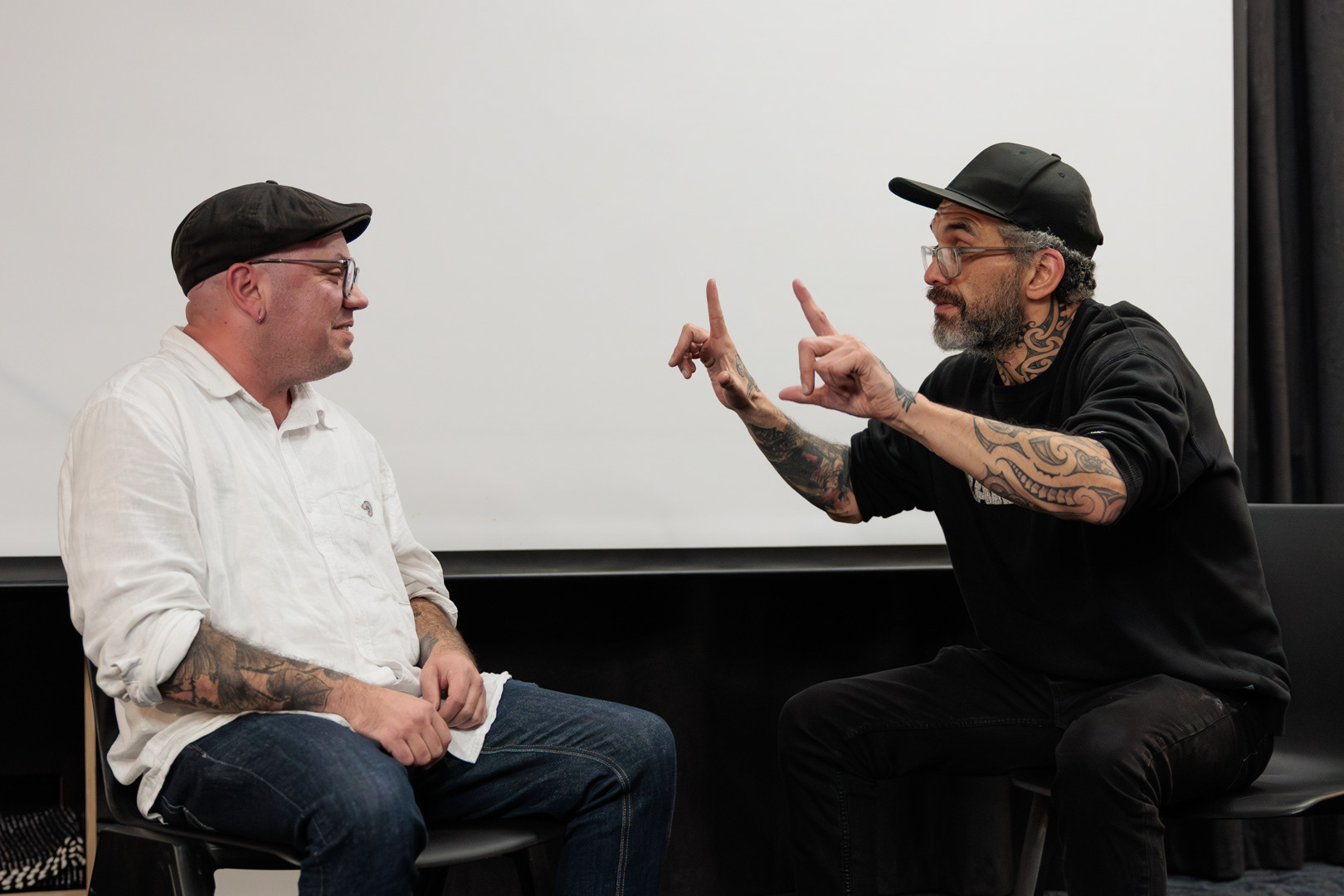 Jared Flitcroft and Stace Robertson converse in NZSL at the Arts Access Aotearoa AGM 2026
