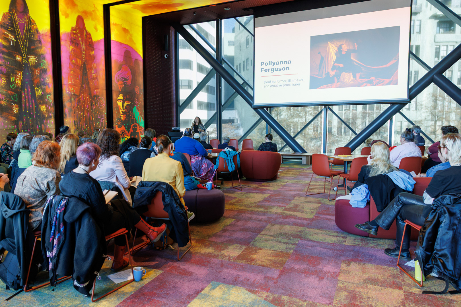 Attendees from all around Greater Wellington listen as Polly Ferguson presents in NZSL to the hui group.