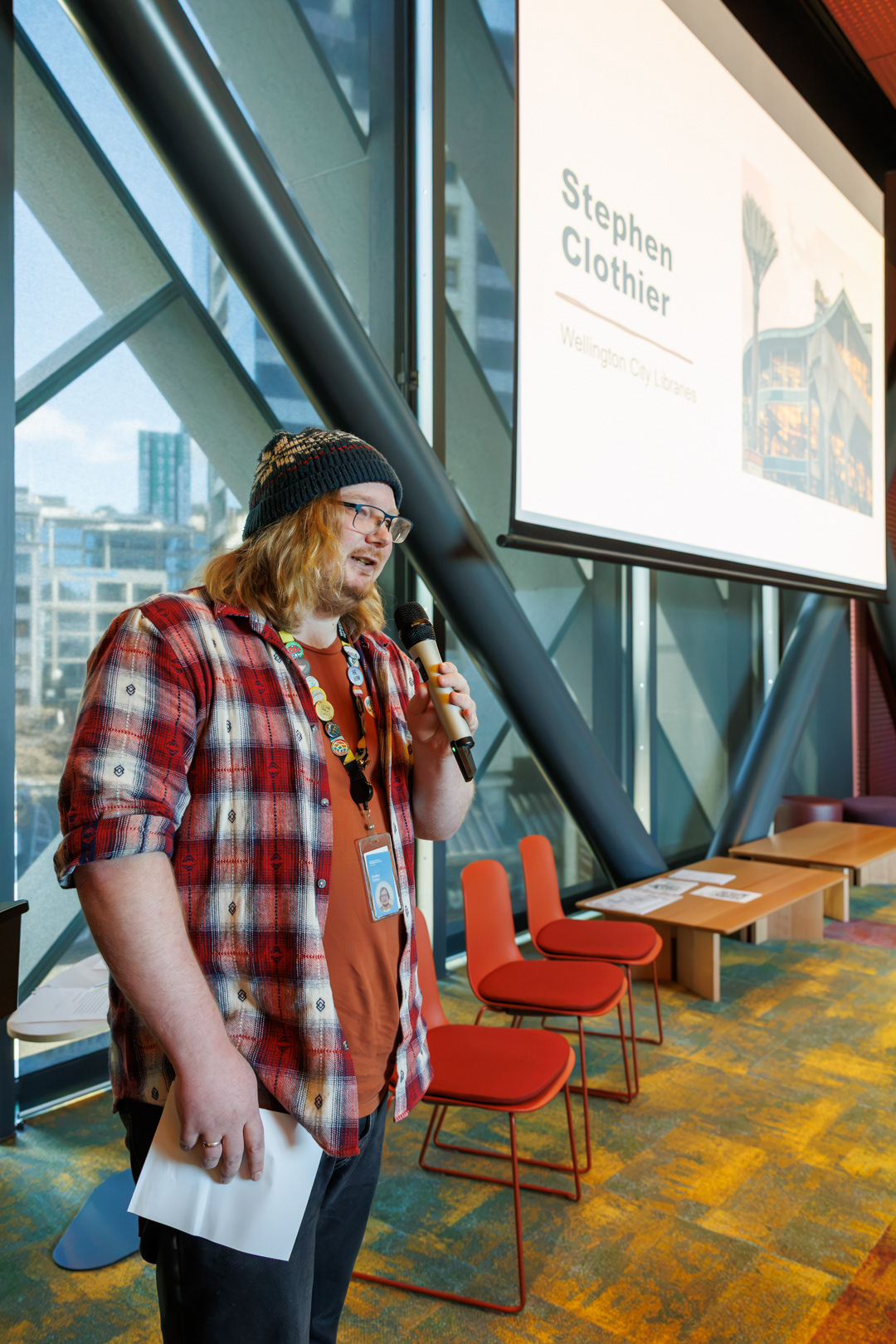 Stephen Clothier, Wellington City Library employee, presents in front of the hui group.