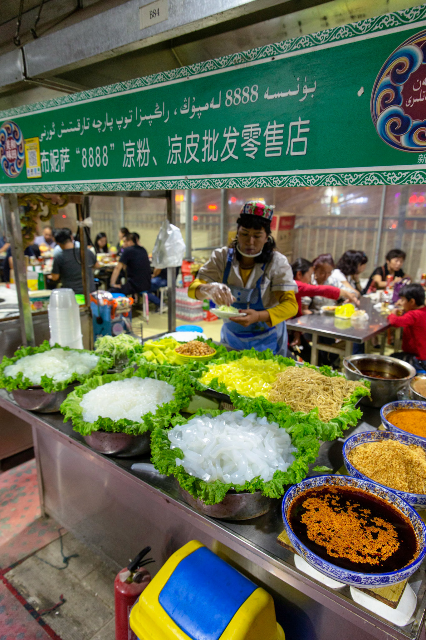 Hotan, China - September 12th 2018 : Preparing fresh cold noodle food in the Hotan food bazaar