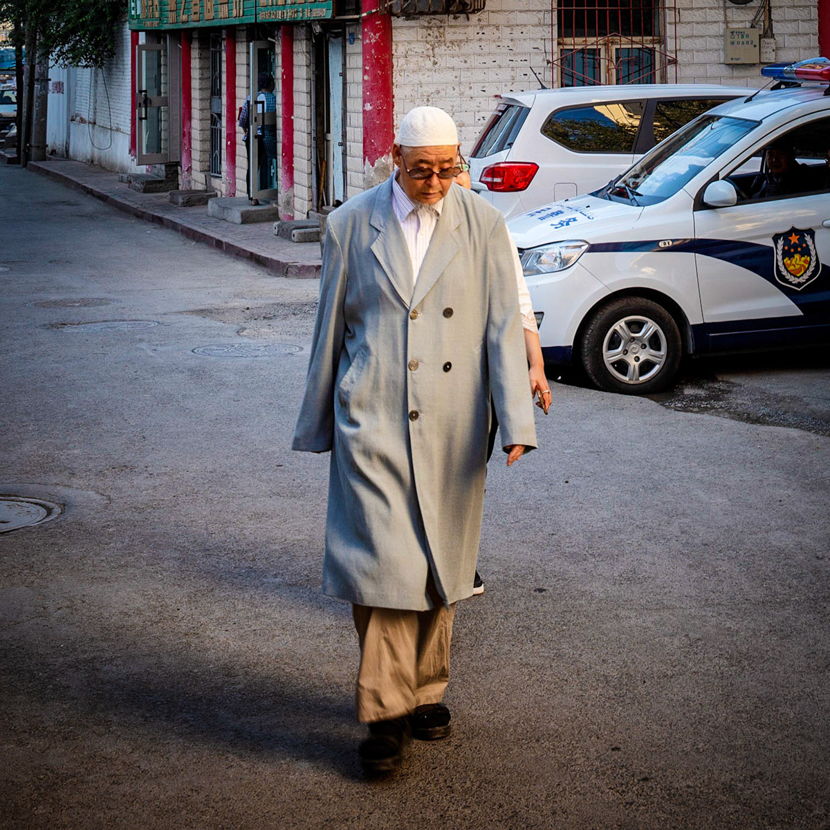 Urumqi, China - september 1, 2018 :  Man wearing muslim headwear walking on the street of Urumqi