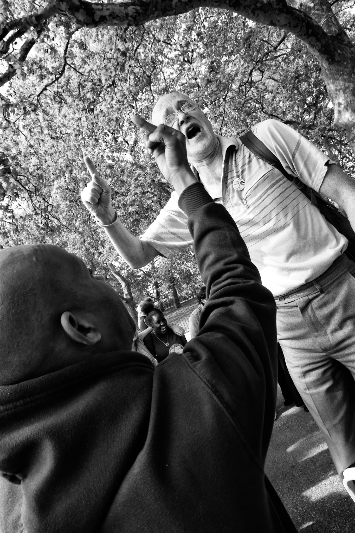 London, United kingdom - May 1, 2011 :  Hyde Park, Speaker's corner, man holding a speech on the subject of faith, is arguing vehemently with a member of his audience. Speaker's corner has been a free speech area where open-air public speaking and debate is encouraged. Although public speaking is actually allowed everywhere in the UK, the speaker's corner is traditionally the place where, as long as lawful, the most controversial issues can be aired.