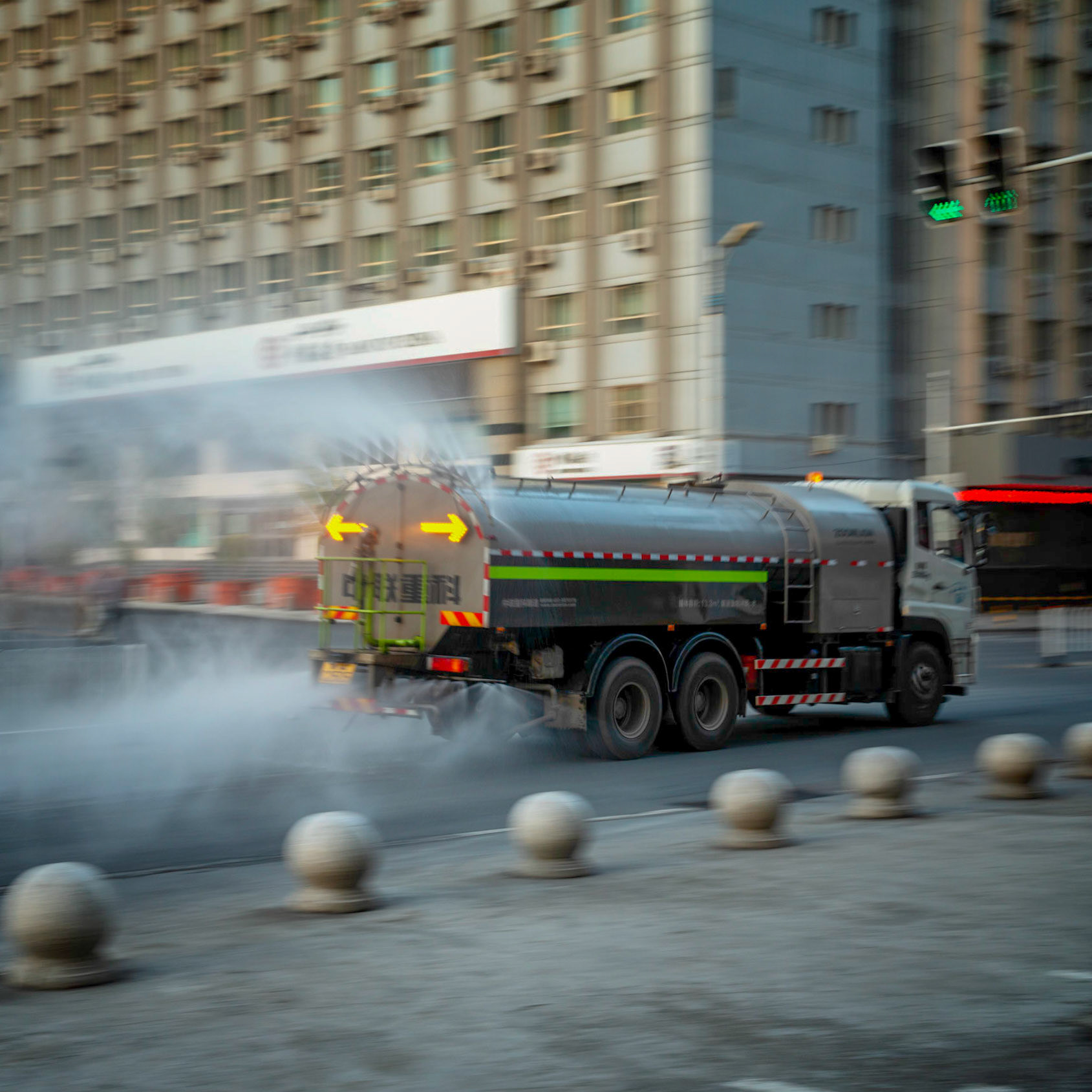 Urumqi, China - september 1, 2018 :  Truck spraying water on the streets of Urumqi in the early morning