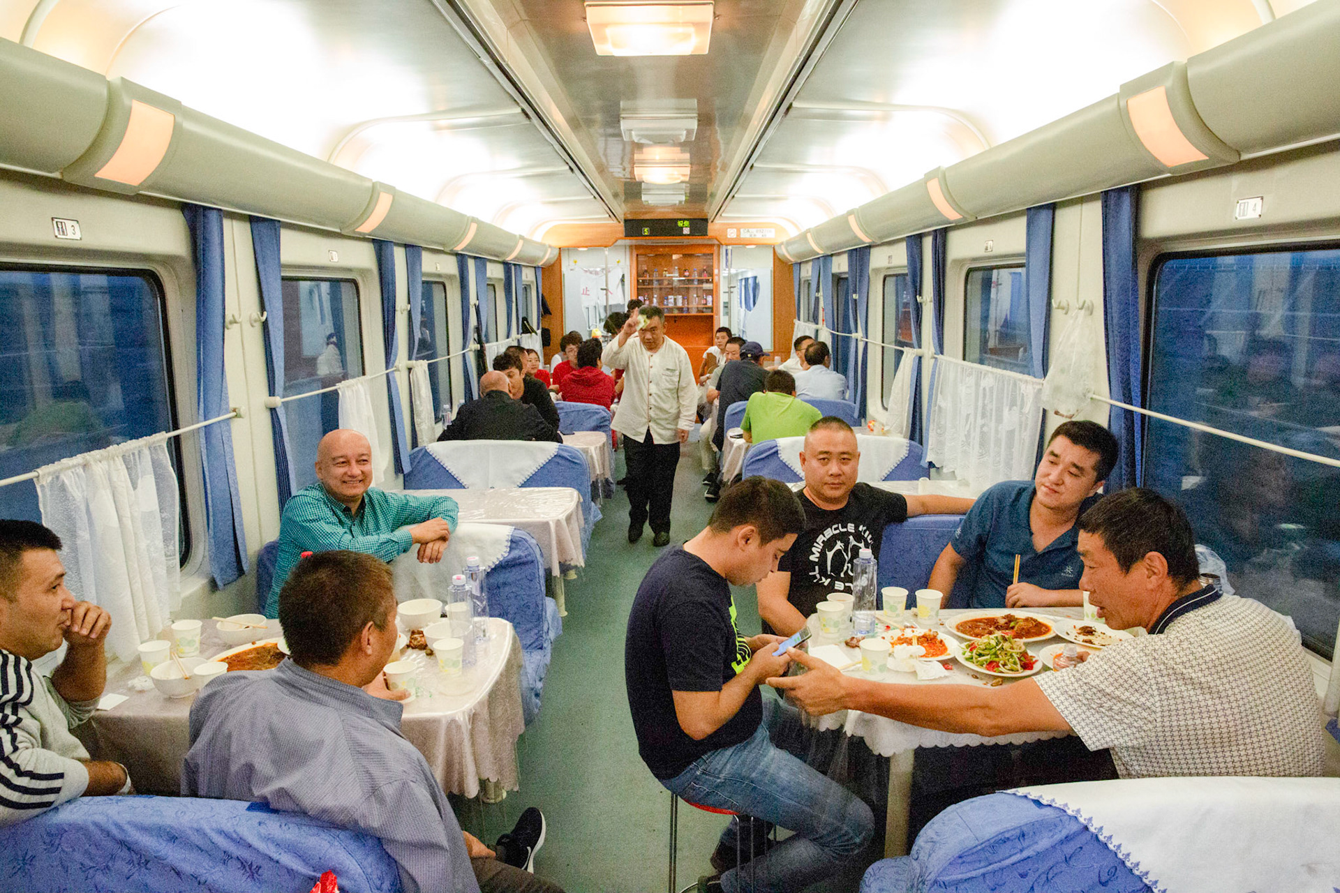 Urumqi, China - september 4, 2018 :  Staff having dinner in the restaurant carriage in the Urumqi - Kashgar train