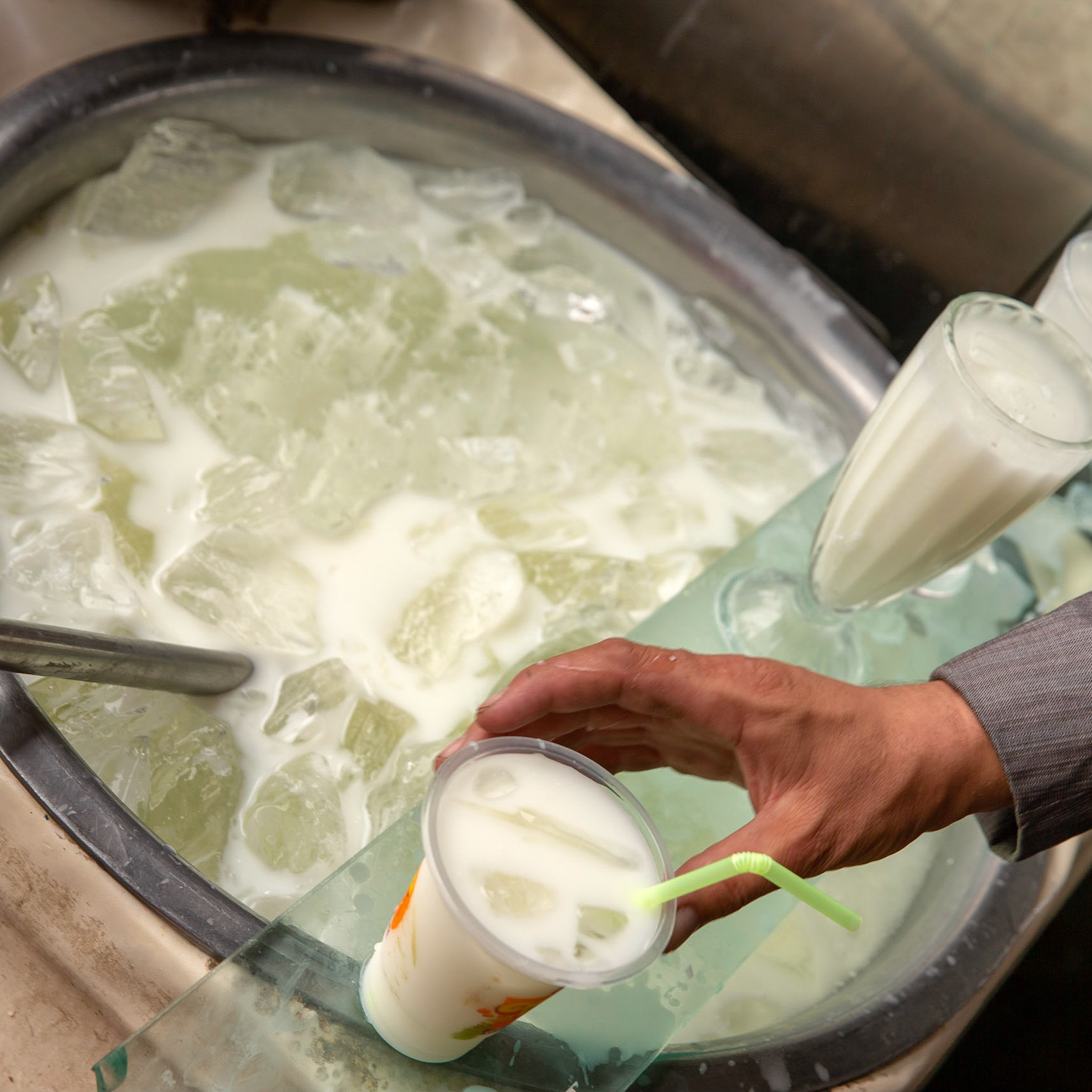 Preparing fresh icecold yoghurt drink at the Kashgar bazaar.