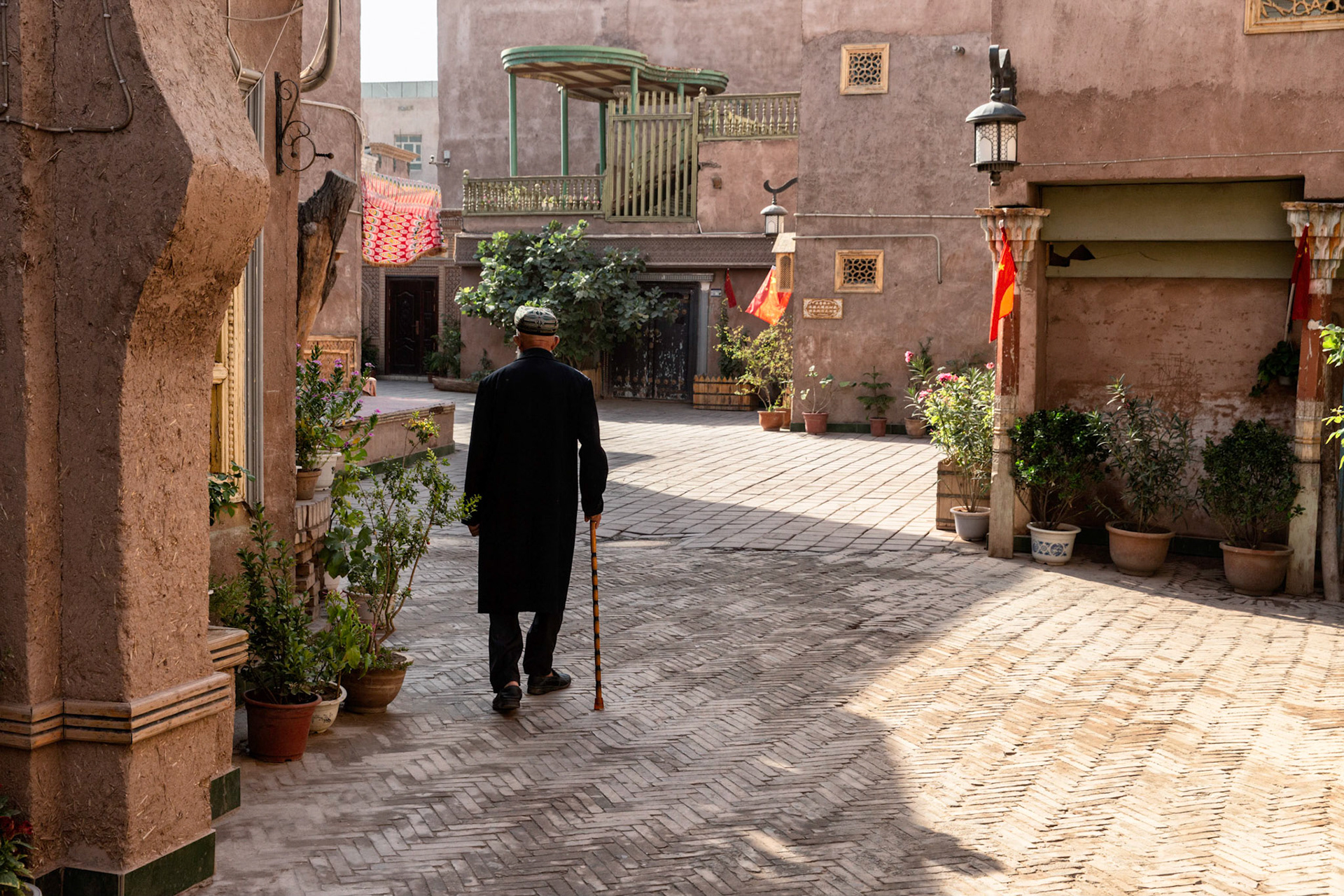 Kashgar,  China - September 11th, 2018 : Uyghur muslim man walking with a cane in the old city of Kashgar