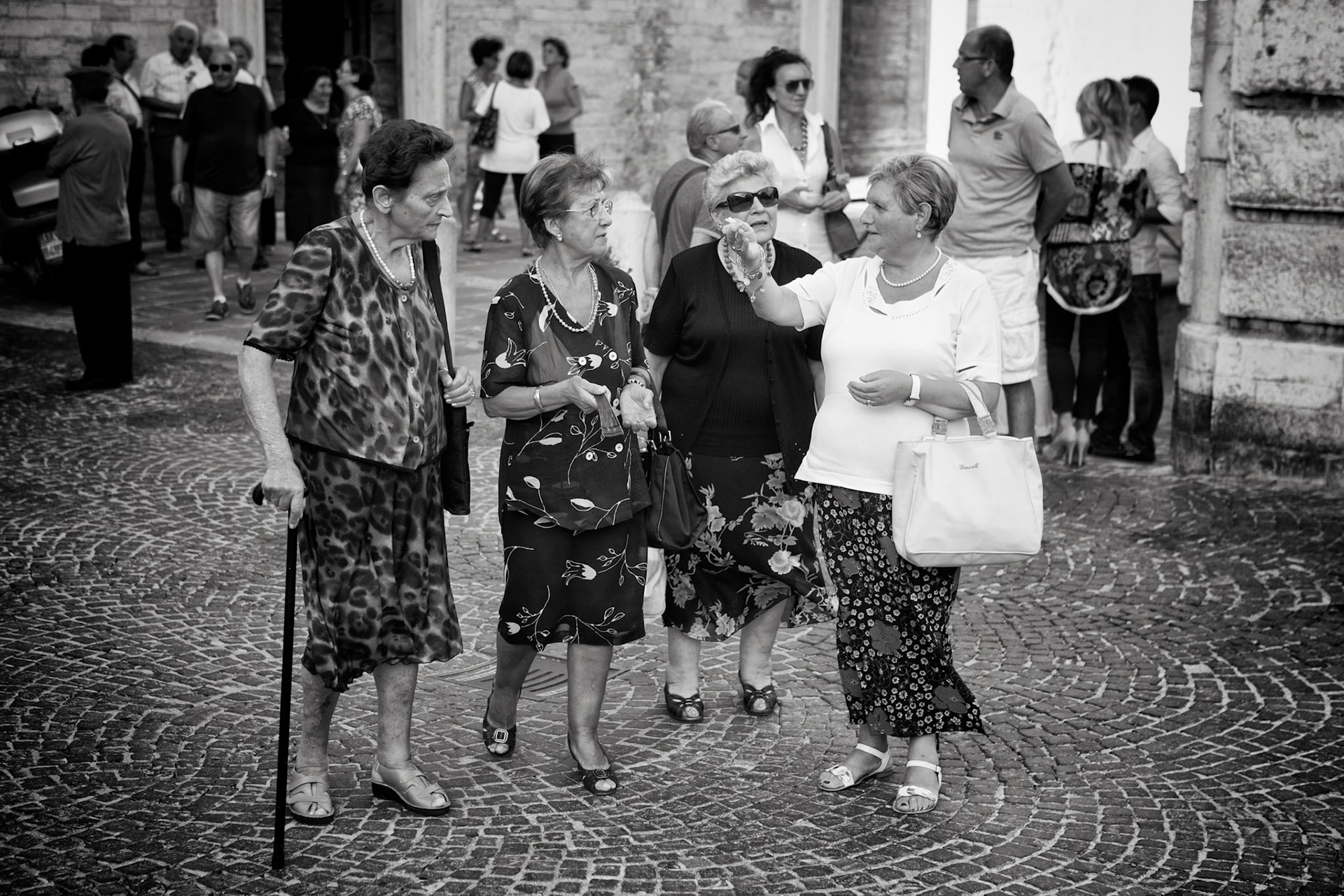 Cagli, Italy - July 29th 2012: senior people walking across the cobblestones of Cagli village square Tourists and locals in the background  [url=http://www.istockphoto.com/search/lightbox/11293042#64eec1d][img]http://www.piebinga.nl/banners/italy.jpg[/img][/url]