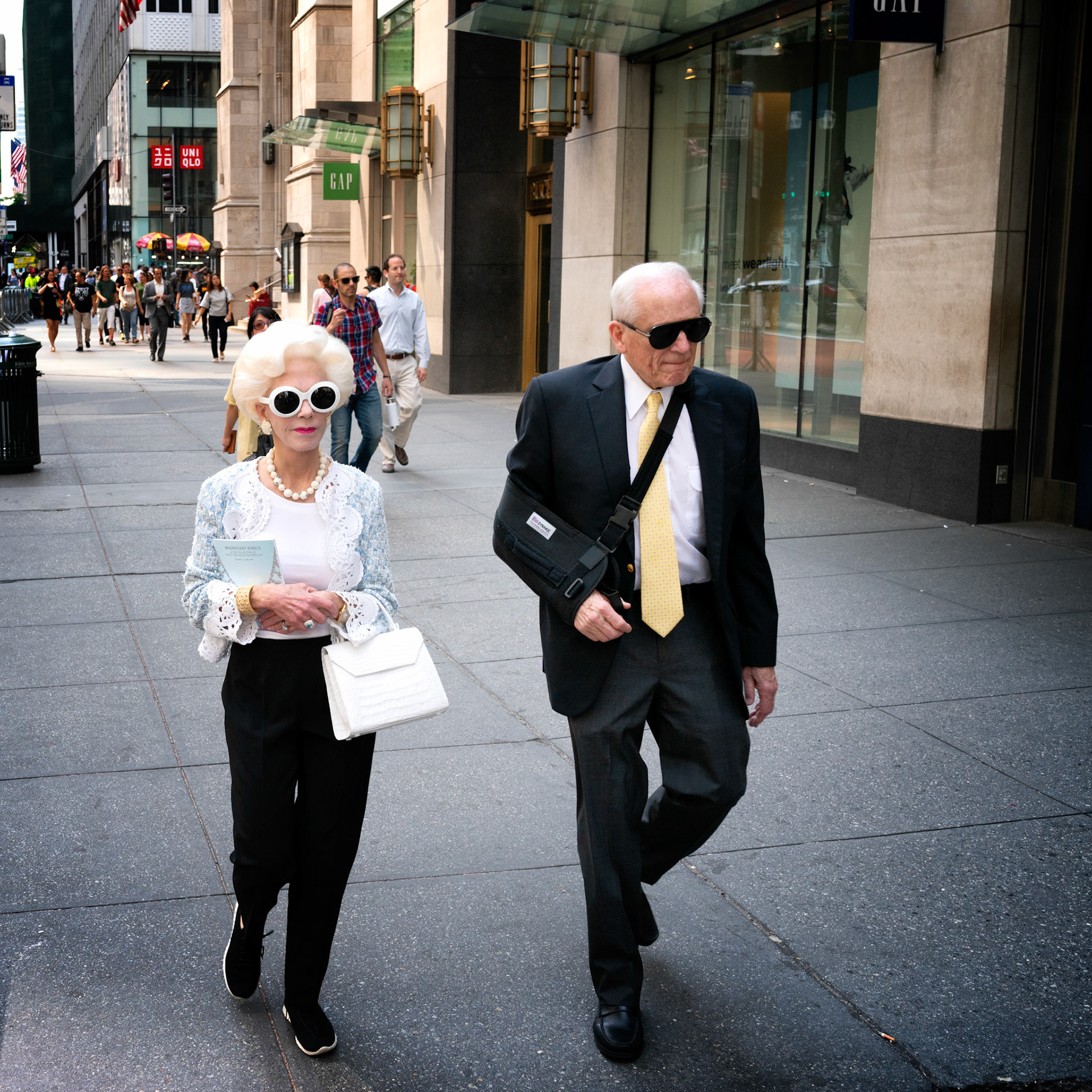 New York, USA - June 8th 2018 : senior adult couple walking ont he streets of new york, wearing sunglasses