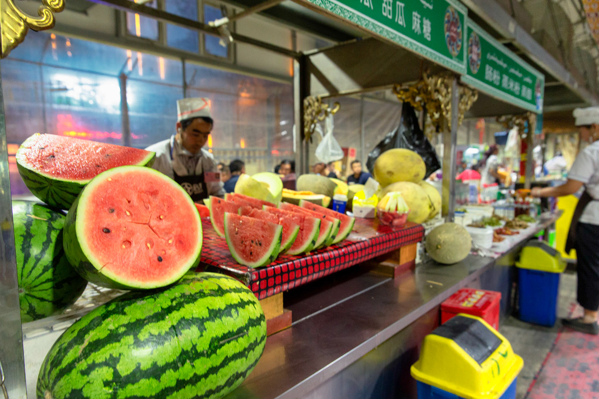 Hotan, China - September 12th 2018 : Preparing fresh melon in the Hotan food bazaar