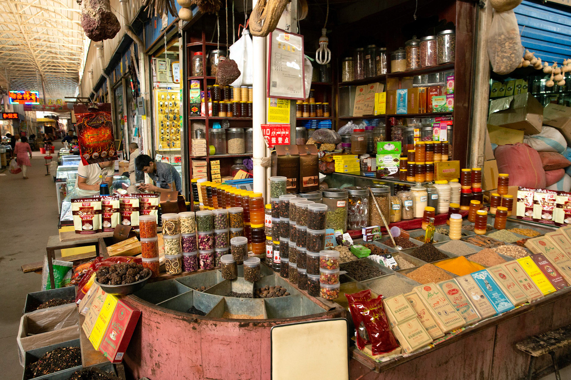 Kashgar, Xinjiang, China - September 5, 2018: Spices, dried fruit and honey in a well-stocked stall insidd the Kashgar grand bazaar.