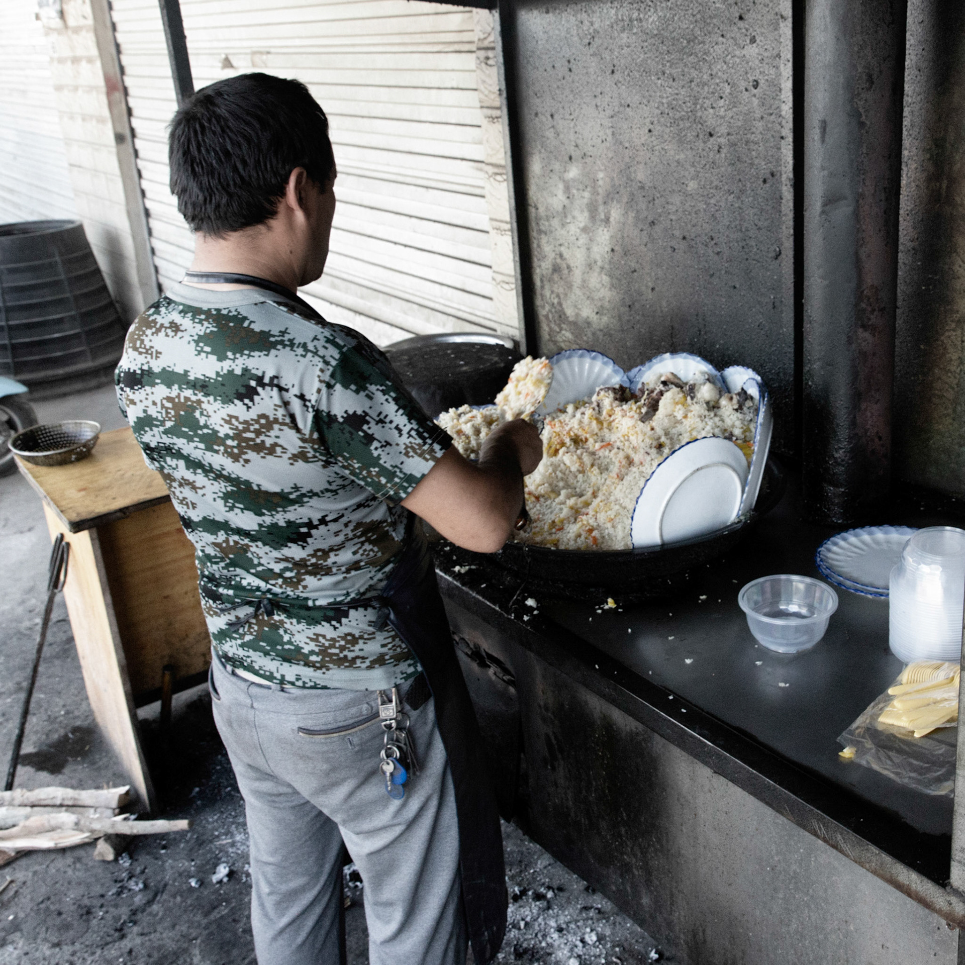 Kargilik, China - september 12th 2018: Preparing a rice and fruit meal in a small restaurant