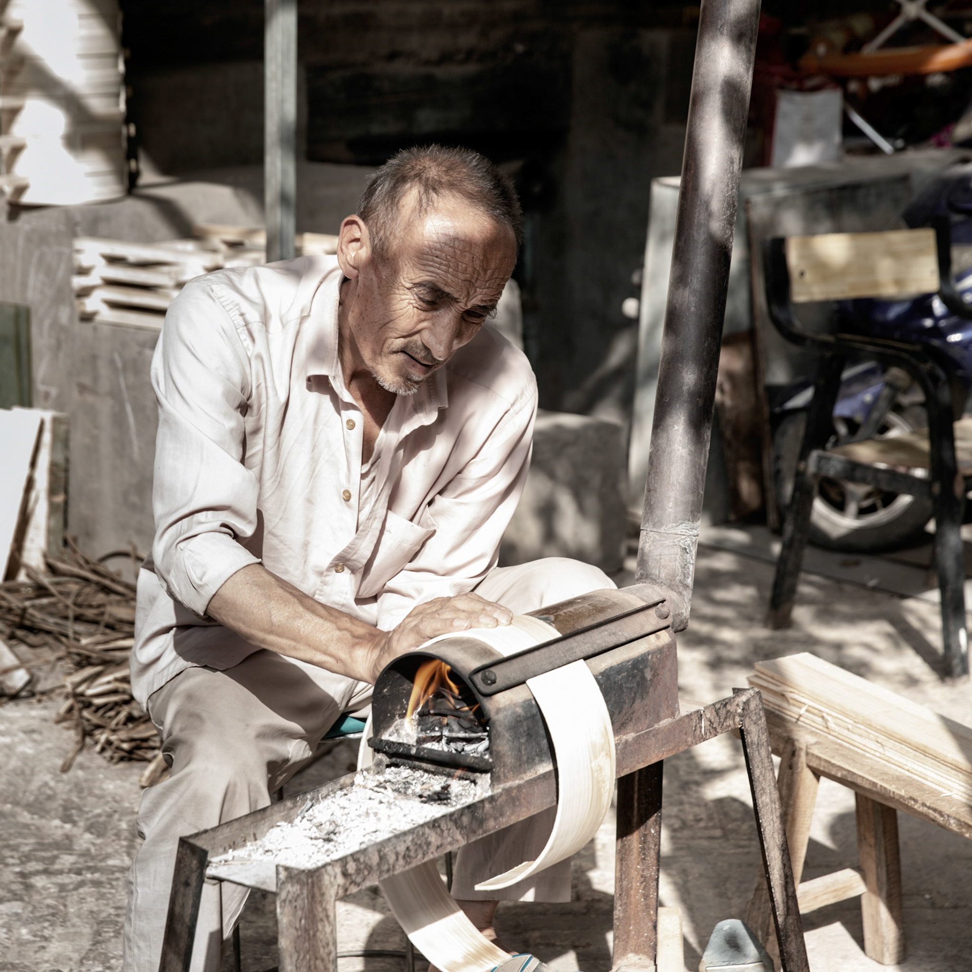 Kashgar,  China - September 11th, 2018 : Uyghur working with wood in a a small woodworking factory
