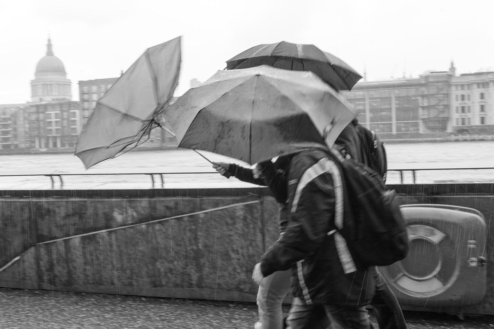 London, United Kingdom - June 15th, 2012 : People walking in pooring London rain.